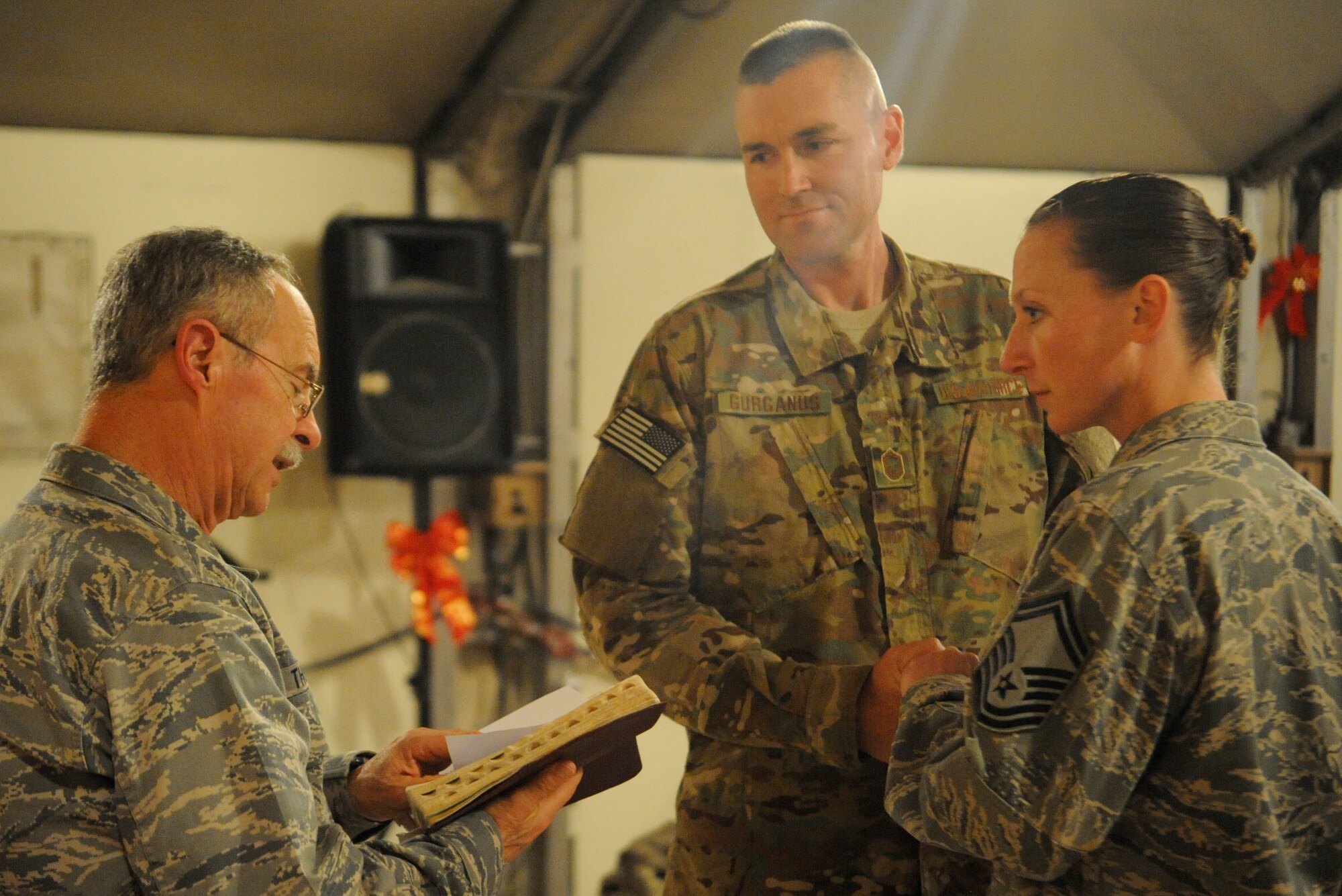 Chaplain (Lt. Col.) Steven Thompson conducts a vow renewal ceremony for Senior Master Sgts. Don Gurganus and Jen Segerson at the Transit Center at Manas, Kyrgyzstan, Nov. 30, 2011. Gurganus and Segerson both passed through the Transit Center on their way to Afghanistan. Gurganus will be the American Forces Network superintendent at the New Kabul Compound and Segerson will be the Bagram Airfield communications superintendent. The couple is deployed from Ramstein Air Base, Germany. Thompson is a 376th Air Expeditionary Wing chaplain deployed here from the Florida Air National Guard’s 125th Fighter Wing. (U.S. Air Force photo/Tech. Sgt. Tammie Moore)