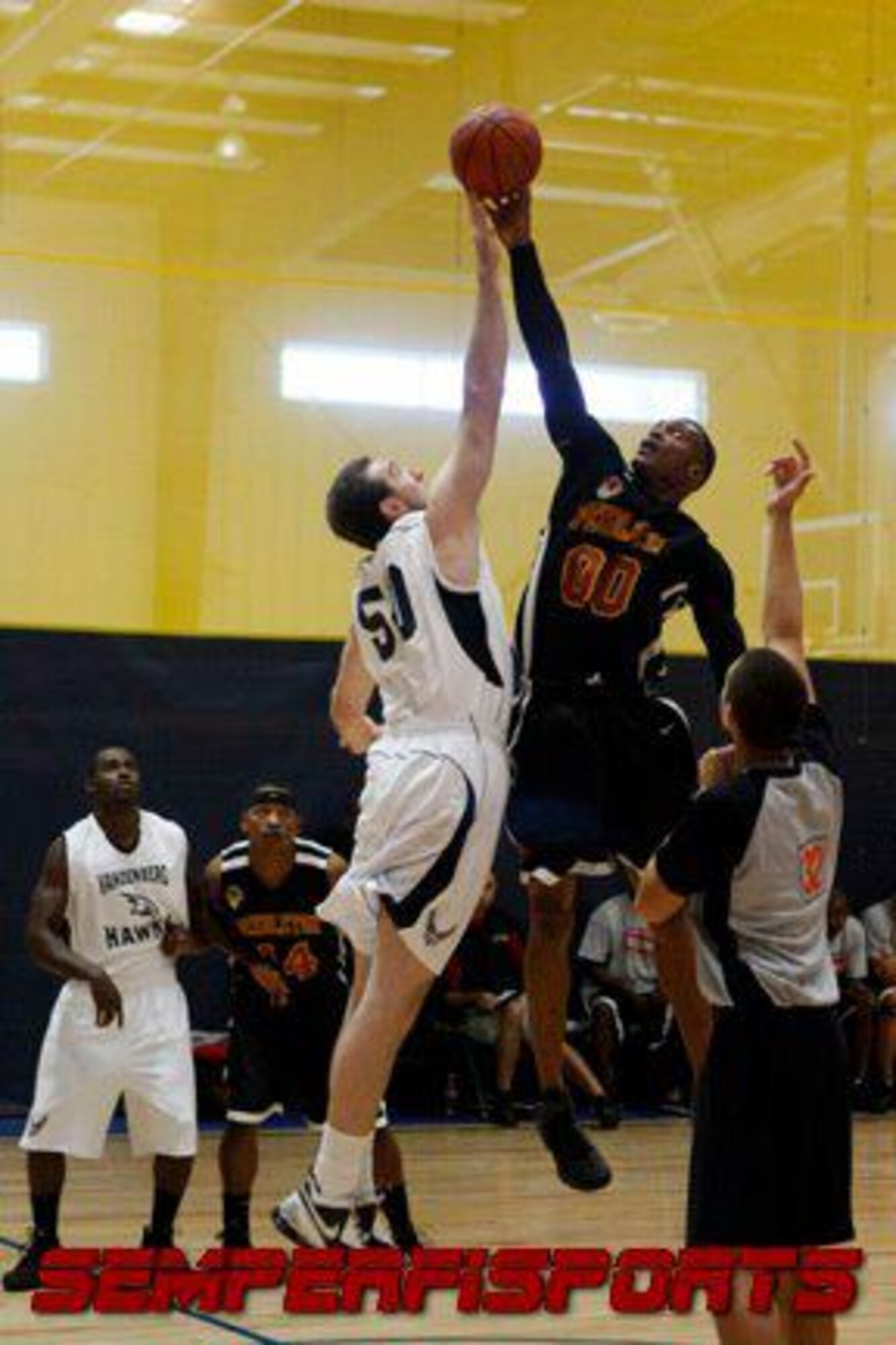 CAMP PENDLETON, Calif. - Phillip Gellentien, a 30th Force Support Squadron graphic designer and Vandenberg Hawk team member, battles for the game ball with a Camp Pendleton varsity team member during tipoff at a league game here Saturday, Nov. 5, 2011. (Courtesy photo) 