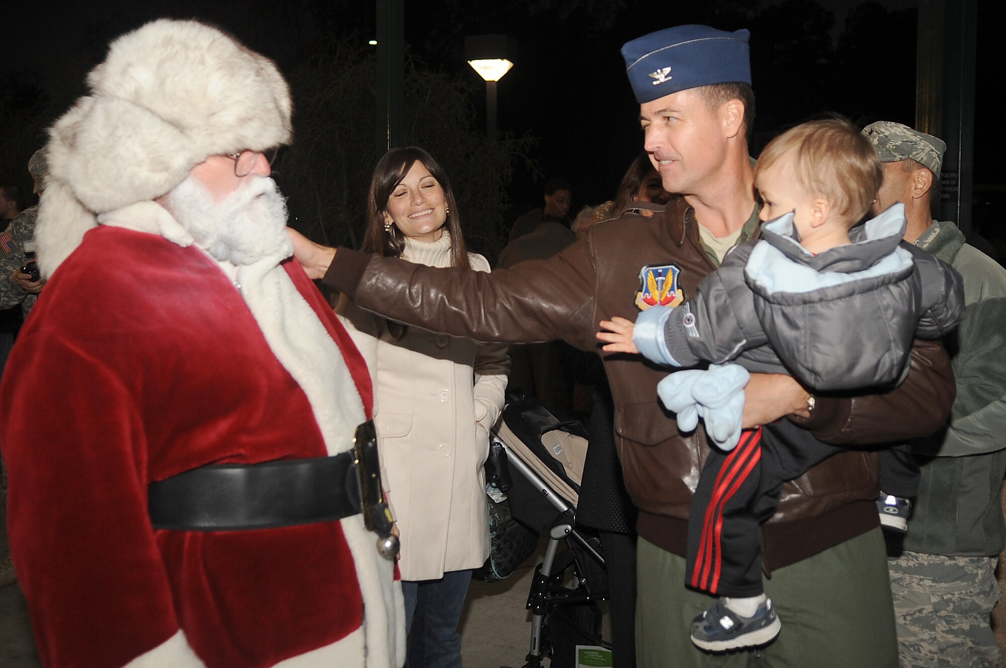 U.S. Air Force Col. Charles Moore, 20th Fighter Wing commander, thanks Santa for arriving at the Christmas Tree Lighting Ceremony, Shaw Air Force Base, S.C., Nov. 30, 2011. The Christmas Tree Lighting Ceremony was put together by Shaw's Chaplains, and is held annually to signify the beginning of Christmas holiday activities. (U.S. Air Force photo by Airman First Class Hunter Brady/Released)







