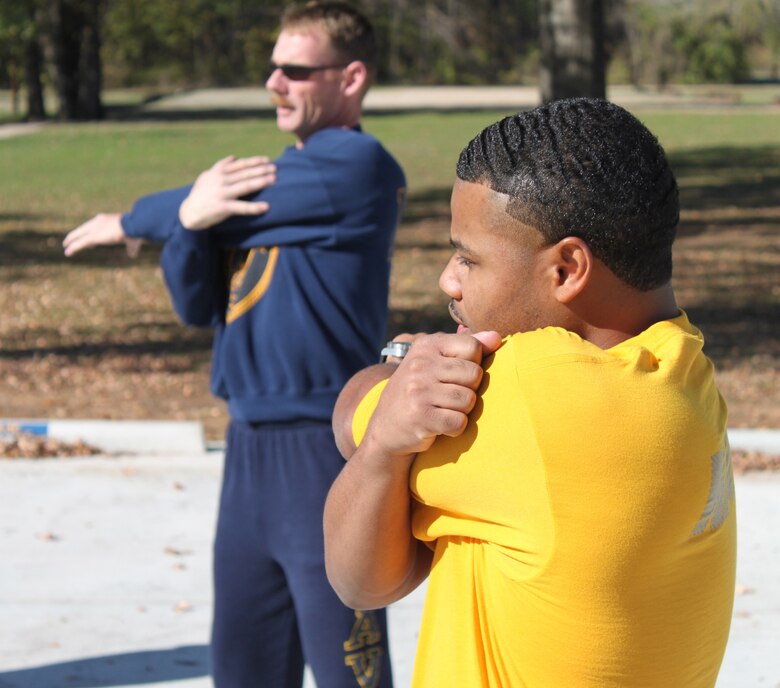 Seabees from the 28th Naval Mobile Construction Battalion stretch before exercising on Barksdale Air Force Base, La., Dec. 1. The Seabees are capable of performing horizontal, vertical, specialty and utility construction. (U.S. Air Force photo/Airman 1st Class Micaiah Anthony)(RELEASED)