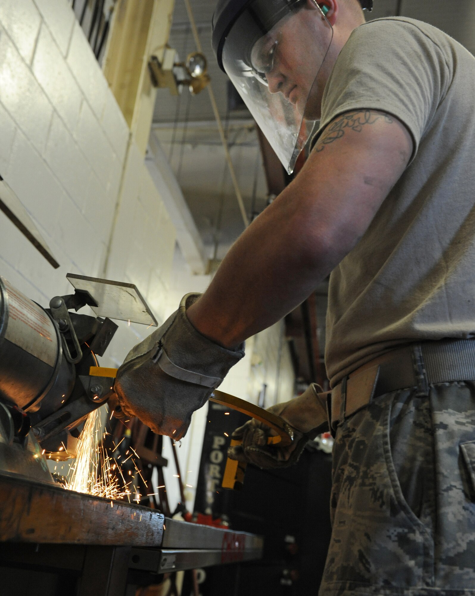 Senior Airman Justin Morrison, 2nd Logistics Readiness Squadron vehicle maintenance journeyman, smoothes out the surface of a crane's safety latch on Barksdale Air Force Base, La., Dec. 1. From Humvees to cranes, Airmen from the 2 LRS vehicle maintenance facility are capable of repairing any type of government vehicle. (U.S. Air Force photo/Airman 1st Class Micaiah Anthony)(RELEASED)