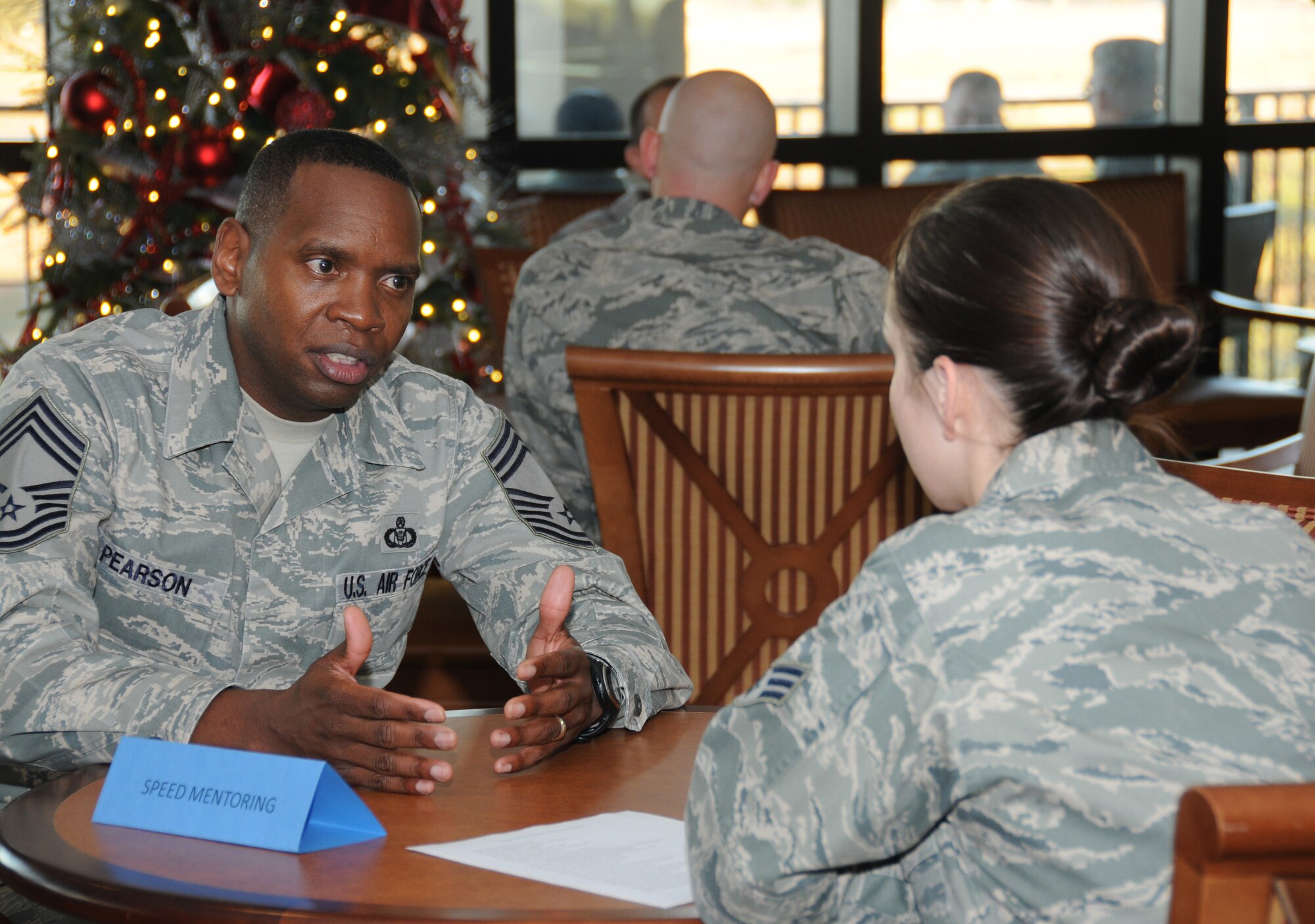 Chief Master Sgt. Anthony Pearson, 334th Training Squadron, provides mentoring tips to Senior Amn. Kayla Spiel, 81st Medical Operations Squadron, during a speed mentoring program at the Bay Breeze Event Center, Keesler Air Force Base, Miss., Nov. 30, 2011.  The program was organized by the Keesler Career Assistance advisor, Senior Master Sgt. Steven Mullens, to provide mentorship to Airman Leadership School students from various senior NCOs.  (U.S. Air Force photo by Kemberly Groue)