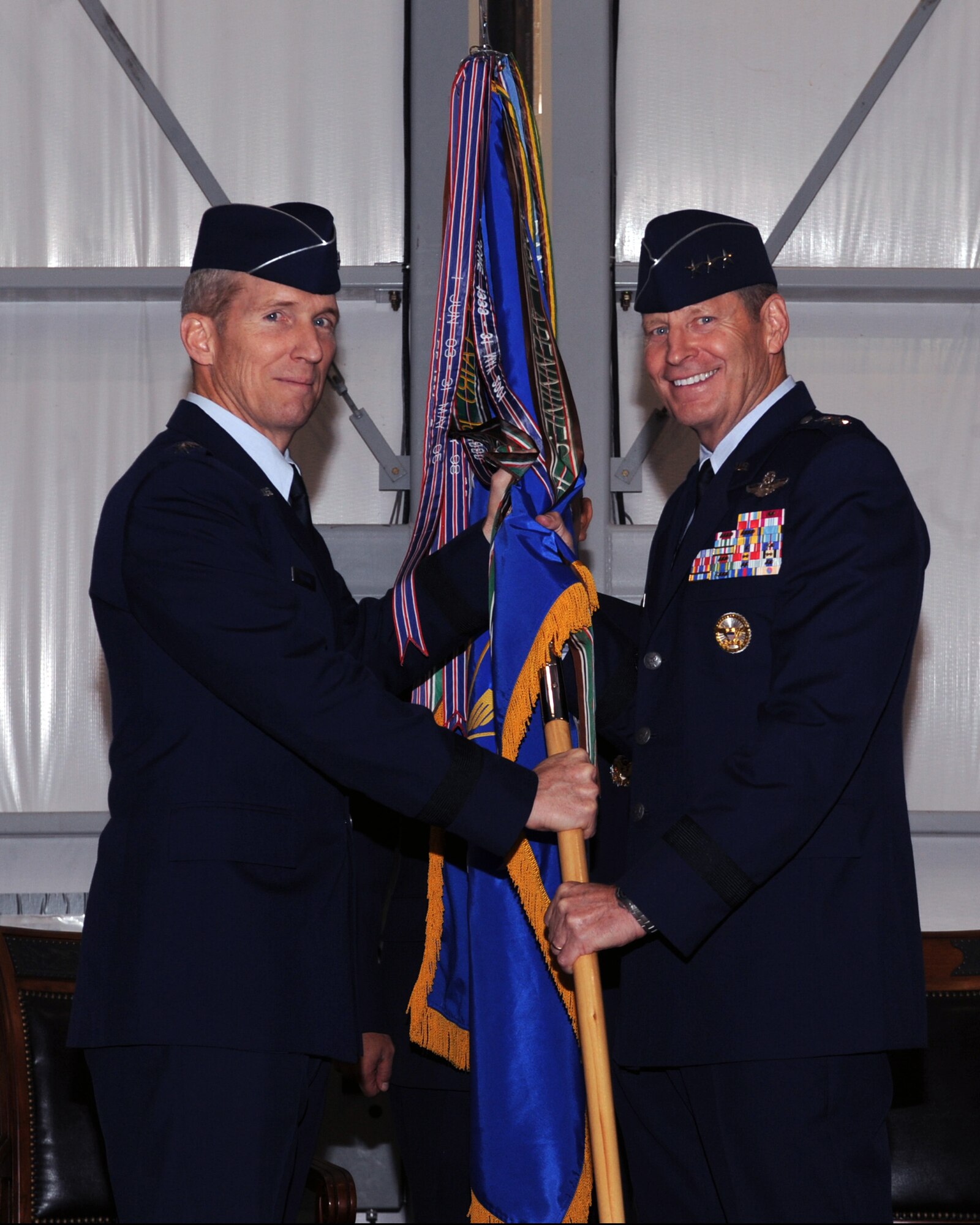 U.S. Air Force Lt. Gen. Robin Rand (right) receives the 12th Air Force (Air Forces Southern) guidon from U.S. Air Force Gen.  Mike Hostage, commander of Air Combat Command, during the assumption of command ceremony at Davis-Monthan Air Force Base, Ariz., Dec. 1. As the air component commander of U.S. Southern Command, the general will conduct security cooperation and provide air, space and cyberspace capabilities throughout the 31 nations of Latin America and the Caribbean. (U.S. Air Force photo by Airman 1st Class Christine Griffiths/Released)