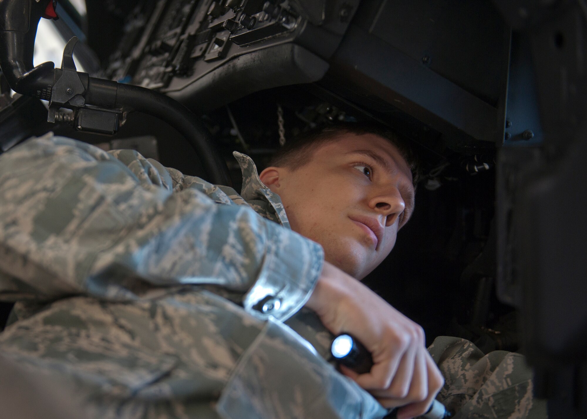 U.S. Air Force Senior Airman Kurt Meier, 723rd Aircraft Maintenance Squadron, gets a closer look at an HH-60G Pave Hawk cockpit while it undergoes maintenance at Moody Air Force Base, Ga., Nov. 30, 2011. Maintenance for HH-60s requires that every 1,200 flying hours it is sent to Elizabeth City, N.C., or Corpus Christi, Texas, to be inspected for small problems such as corrosion and paint touchups. (U.S. Air Force photo by Senior Airman Eileen Meier/Released)