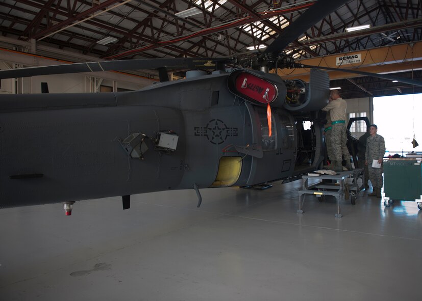 U.S. Air Force Airmen from the 723rd Aircraft Maintenance Squadron and 23rd Component Maintenance Squadron replace parts and perform general upkeep on an HH-60G Pave Hawk at Moody Air Force Base, Ga., Nov. 30, 2011. The HH-60 recently returned from depot maintenance where more thorough inspections are performed and problems such as chipped paint or corrosion are taken care of. (U.S. Air Force photo by Senior Airman Eileen Meier/Released)