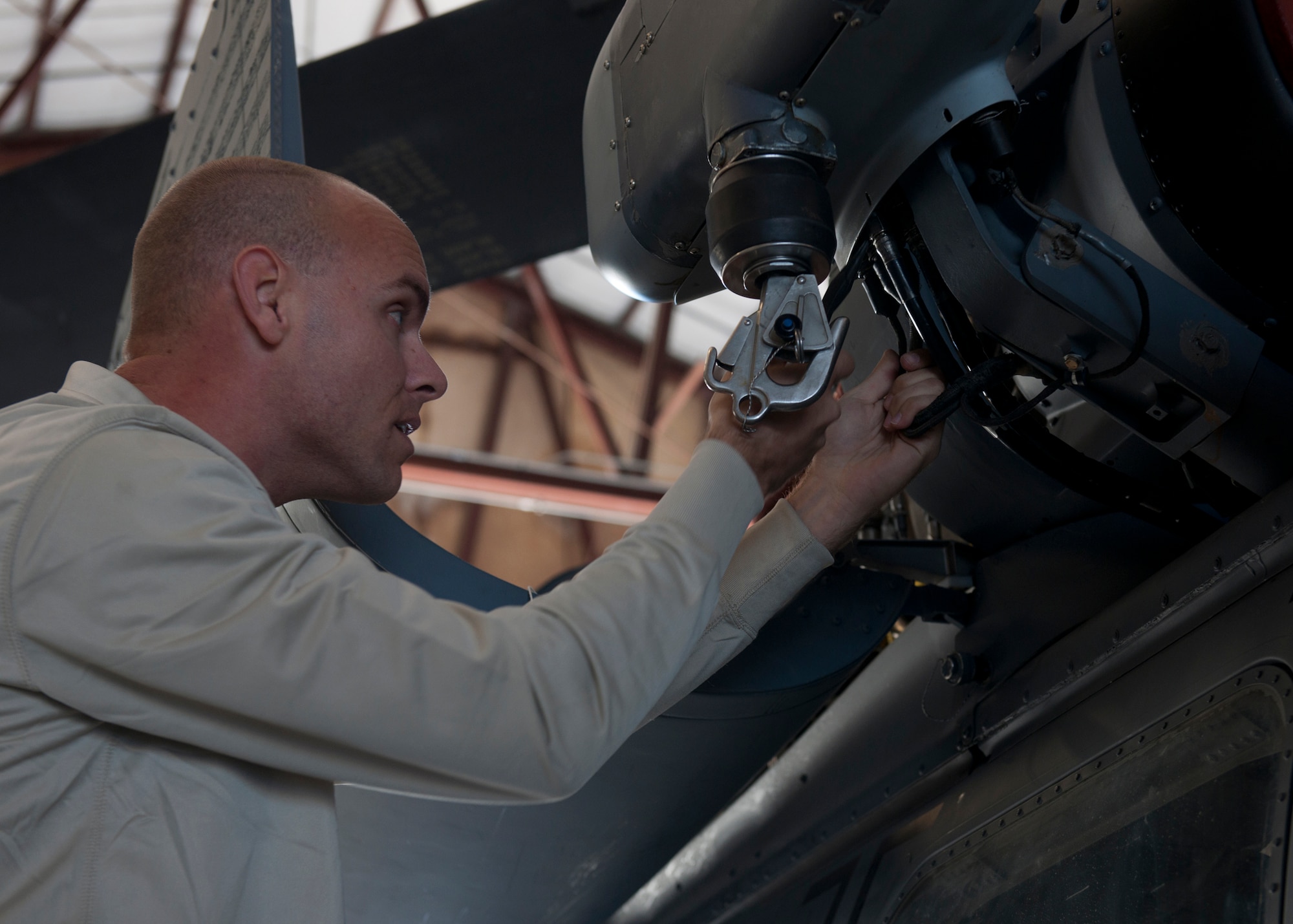 U.S. Air Force Airman 1st Class Joshua Jaynes, 723rd Aircraft Maintenance Squadron, works on replacing a rescue hoist on an HH-60G Pave Hawk at Moody Air Force Base, Ga., Nov. 30, 2011. The hoist has a value worth more than $172,000 and requires skilled maintainers to handle it. (U.S. Air Force photo by Senior Airman Eileen Meier/Released)