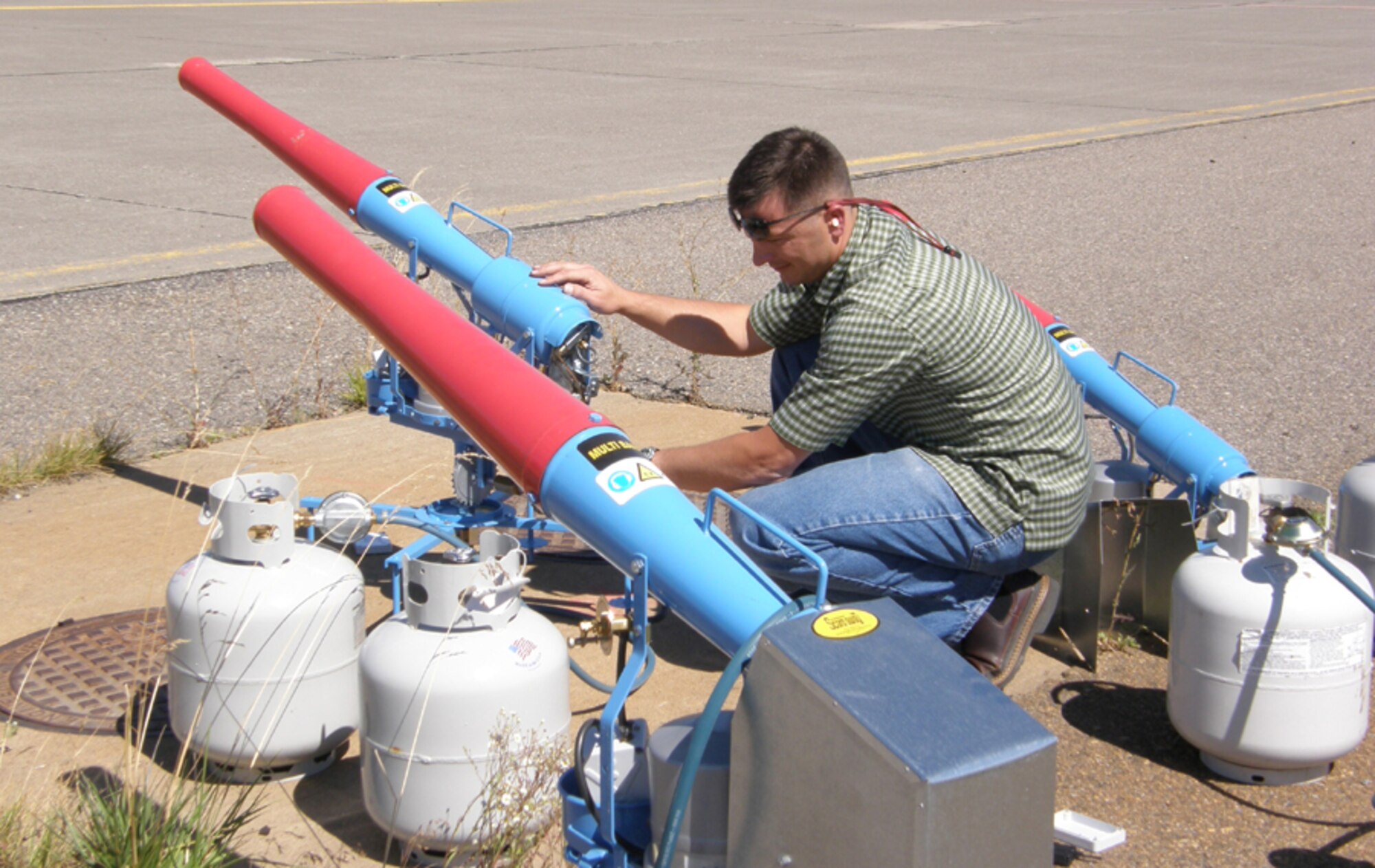 Gibbons sets up bird cannons on the flight line as part of Malmstrom's Bird/Wildlife Aircraft Strike Hazard or BASH program. The cannons are a nonlethal program to deter birds such as Canada geese and gulls from flying near the helicopter movement area. (U.S. Air Force file photo)