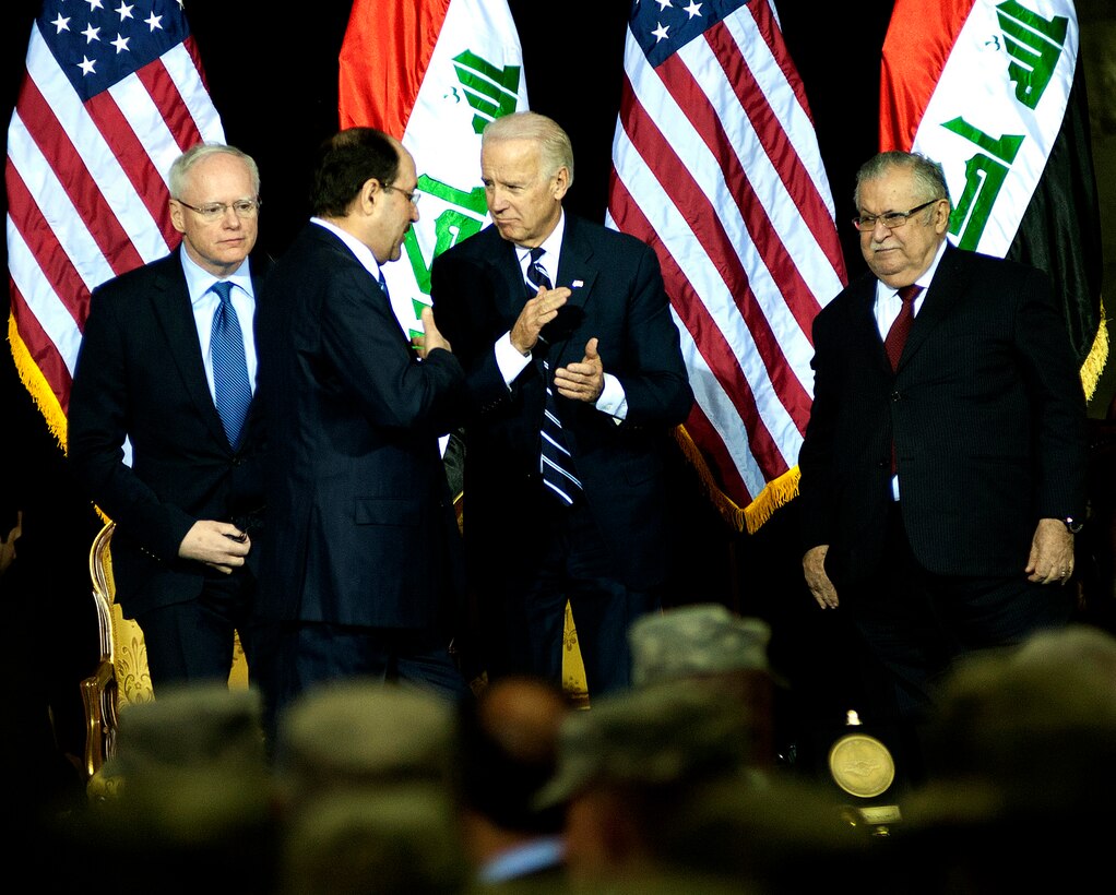 Iraqi Prime Minister Nouri al-Maliki (center left) talks to U.S. Vice President Joe Biden after giving his speech during the Government of Iraq Day of Commitment Ceremony in the Al Faw Palace at Victory Base Complex, Iraq, Dec. 1, 2011. Ambassador to Iraq James F. Jeffrey is on the left and Iraqi President Jalal Talabani is on the right. The ceremony commemorated the sacrifices and accomplishments of U.S. and Iraqi service members. (U.S. Air Force photo/Master Sgt. Cecilio Ricardo)