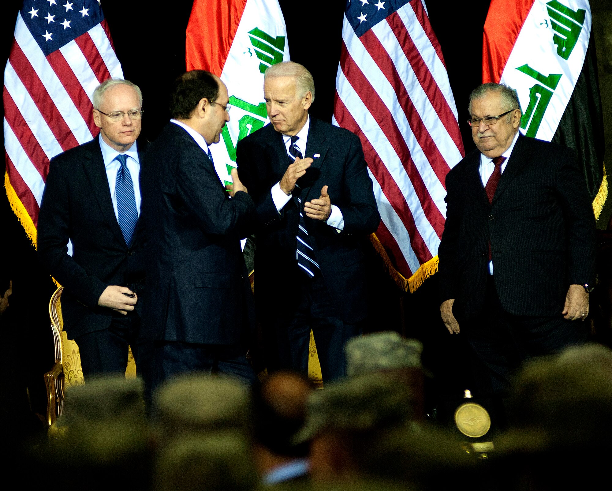 Iraqi Prime Minister Nouri al-Maliki (center left) talks to U.S. Vice President Joe Biden after giving his speech during the Government of Iraq Day of Commitment Ceremony in the Al Faw Palace at Victory Base Complex, Iraq, Dec. 1, 2011. Ambassador to Iraq James F. Jeffrey is on the left and Iraqi President Jalal Talabani is on the right. The ceremony commemorated the sacrifices and accomplishments of U.S. and Iraqi service members. (U.S. Air Force photo/Master Sgt. Cecilio Ricardo)