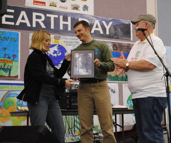 Jason Gibbons, center, biologist with the 341st Civil Engineer Squadron, and Frank Carpenter, environmental protection specialist with the 341st CES, present a photograph of Giant Springs State Park to Janelle Broach during Earth Day events in April. Broach, who volunteered on many "green" projects during her time at Malmstrom, was being recognized for her efforts before moving. (U.S. Air Force file photo)