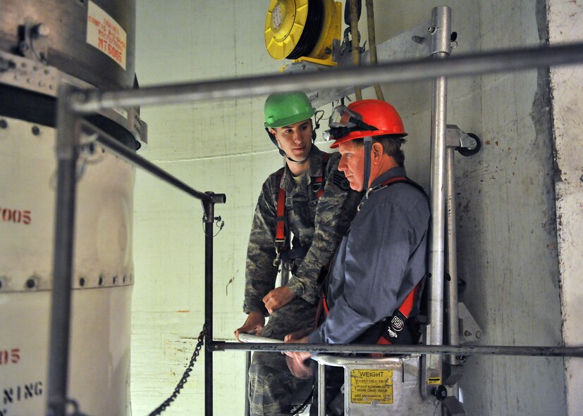 Staff Sgt. Christopher Herridge, 341st Maintenance Operations Squadron MMT team trainer, accompanies Yonkers in the T-9 trainer's work cage Nov. 24. (U.S. Air Force photo/John Turner)