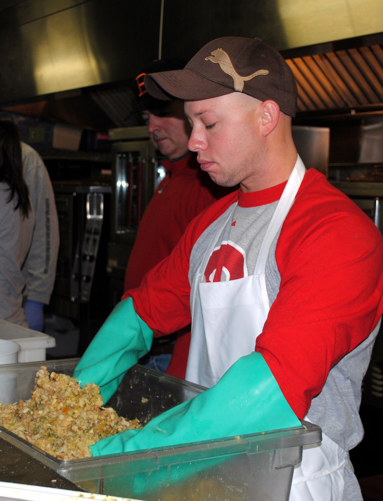 Tech. Sgt. John Miller, missile field evaluator with the 341st Security Forces Group, prepares the stuffing that will be part of the Thanksgiving dinner for Meals on Wheels recipients. (U.S. Air Force photo/Airman 1st Class Katrina Heikkinen)