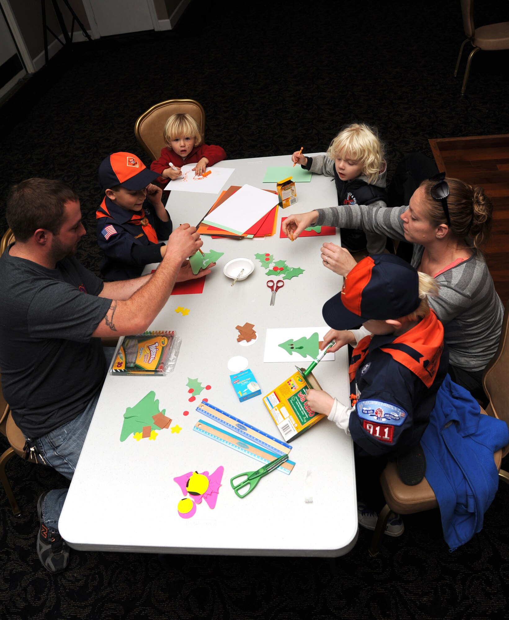 The Meeks and Eubanks families decorate Christmas cards for Seymour Johnson Air Force Base, N.C., Airmen during Christmas Cards for Airmen drive, Nov. 30, 2011. The Christmas card drive was open to base members to make homemade cards for Airmen who are deployed and in the dorms here. (U.S. Air Force photo by Senior Airman Whitney Stanfield) 