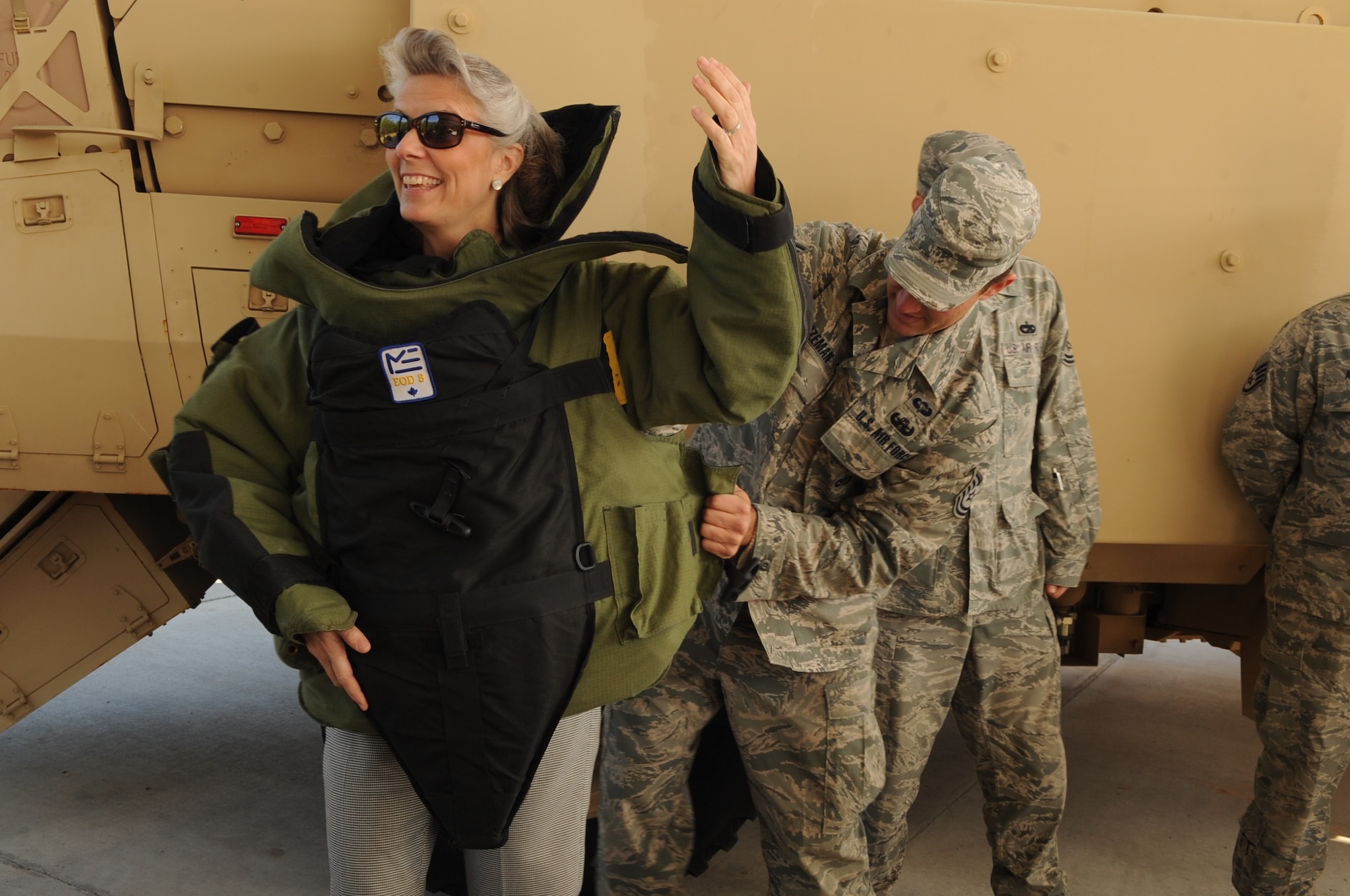 Mrs. Kathy Wells, wife of U.S. Air Force Maj. Gen. Lawrence Wells, 9th Air Force commander, tries on an explosive ordnance disposal suit at Moody Air Force Base, Ga., Nov. 30, 2011. Wells was shown the gear during a visit with the 820th Base Defense Group where she got a chance to learn about their mission capabilities. (U.S. Air Force photo by Airman 1st Class Olivia Dominique/Released)