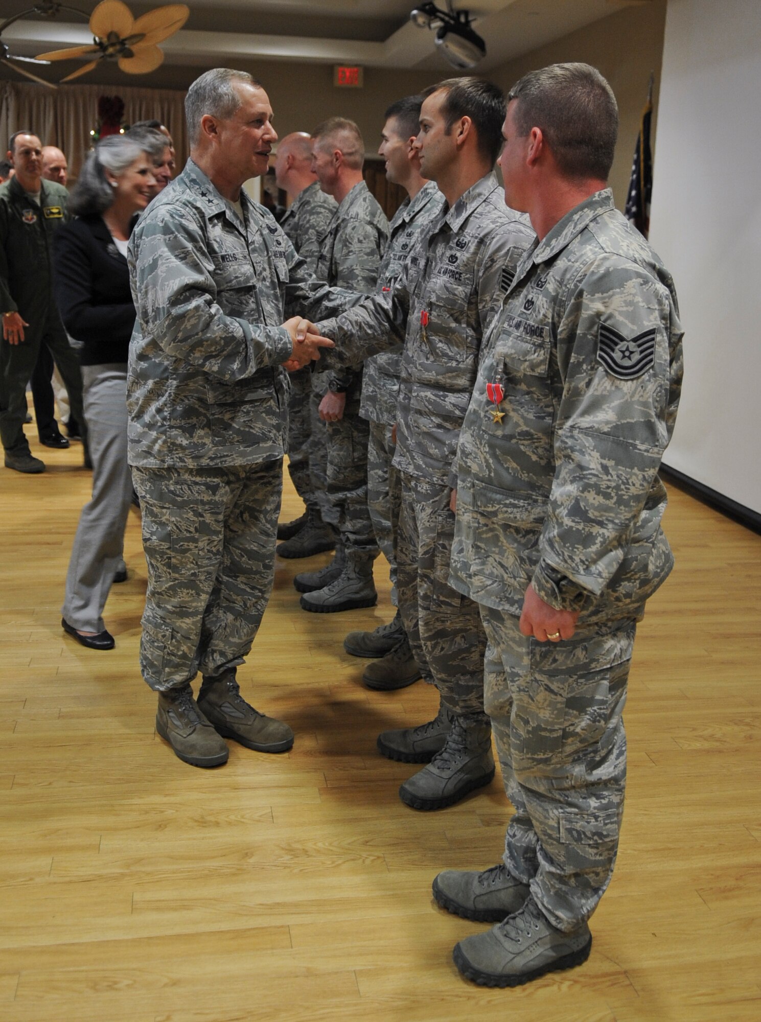U.S. Air Force Maj. Gen. Lawrence Wells, 9th Air Force commander, shakes hands with Airmen after presenting them with Bronze Star Medals at Moody Air Force Base, Ga., Nov. 30, 2011. The medal is given for heroic achievement or service. (U.S. Air Force photo by Airman 1st Class Olivia Dominique/Released)