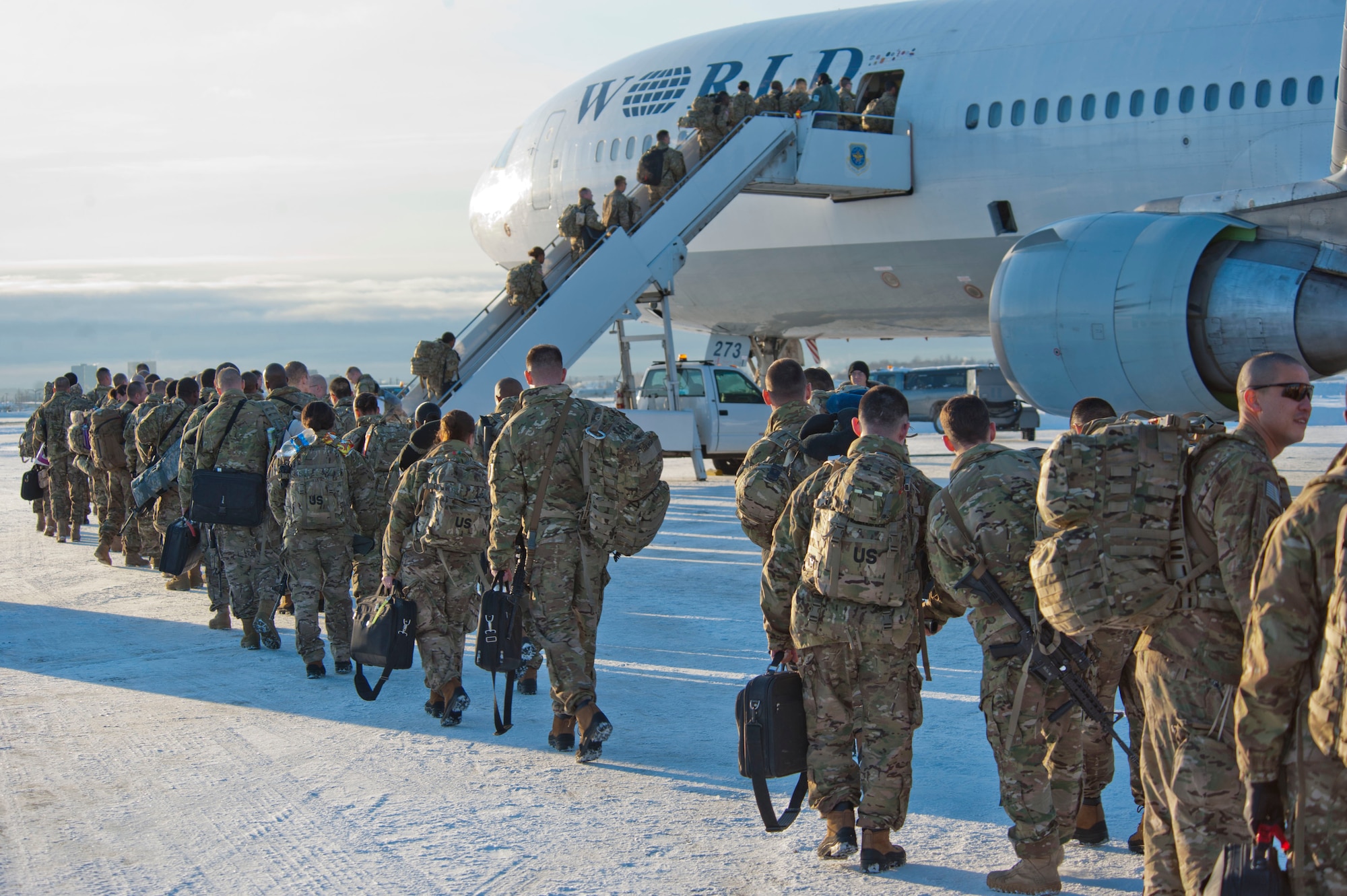 JOINT BASE ELMENDORF-RICHARDSON, Alaska – Soldiers from the 4th Brigade Combat Team (Airborne), 25th Infantry Division load onto a Boeing 737 as they prepare to leave for a deployment to Afghanistan Nov. 28. The 290 Soldiers who left Nov. 28 made up the first big initial departure. Nov. 28 through mid-December more than 3,500 Soldiers are scheduled to depart Joint Base Elmendorf-Richardson en route to Afghanistan. (U.S. Air Force photo/Senior Airman Christopher Gross)