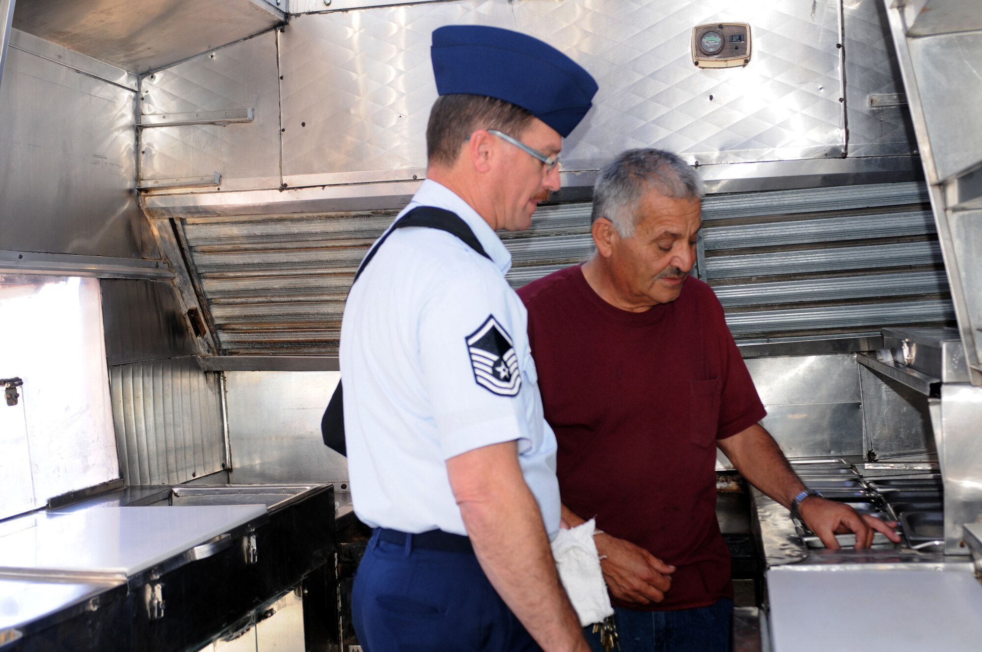Master Sgt. Rick Talvy completes an inspection of the mobile kitchen with “La Herradura” owner Jaime Gomez Nov. 30. Gomez and his team will serve meals on base during the full-time work week, a first for the 162nd Fighter Wing in several years. (U.S. Air Force photo/Maj. Gabe Johnson)