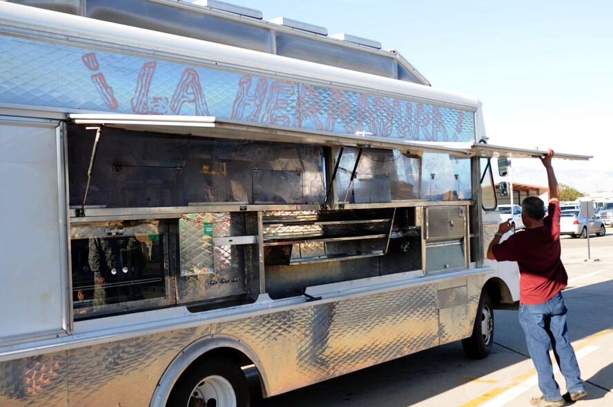 Jaime Gomez, owner of “La Herradura,” or “The Horseshoe,” mobile catering service opens his vehicle for inspection at the 162nd Fighter Wing. Starting Tuesday, Dec. 6, he will begin daily breakfast and lunch service on base. (U.S. Air Force photo/Maj. Gabe Johnson)