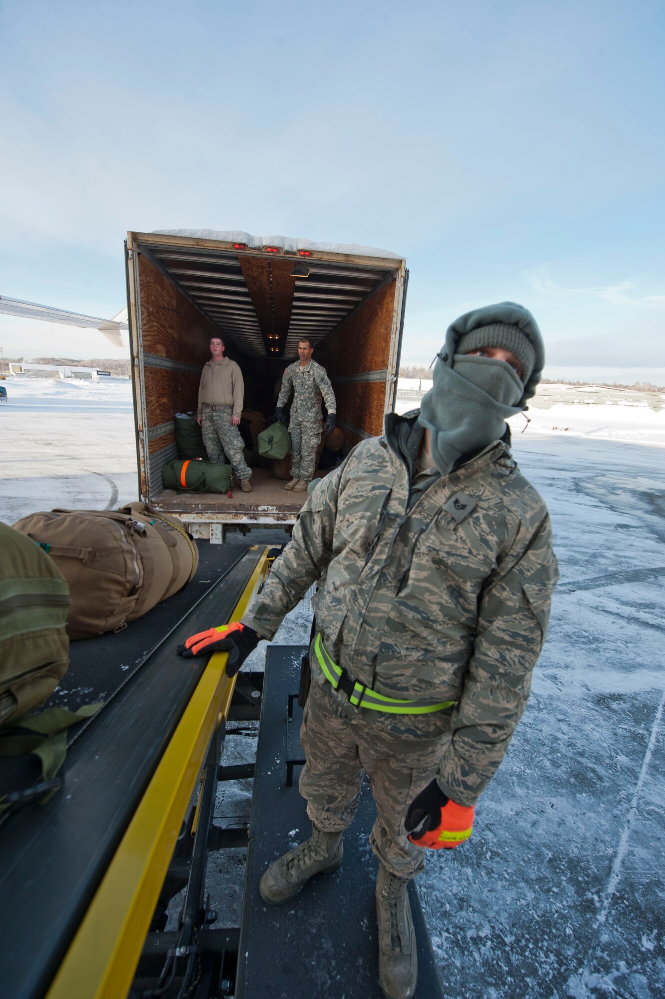 JOINT BASE ELMENDORF-RICHARDSON, Alaska –Air Force Staff Sgt. Christopher Taal , 732nd Air Mobility Squadron, helps load belongings of Soldiers from the 4th Brigade Combat Team (Airborne), 25th Infantry Division onto a Boeing 737 as they prepare to leave for a deployment to Afghanistan Nov. 28. The 290 Soldiers that left Nov. 28 made up the first big initial departure. Nov. 28 through mid-December more than 3,500 Soldiers are scheduled to depart Joint Base Elmendorf-Richardson en route to Afghanistan. (U.S. Air Force photo/Senior Airman Christopher Gross)