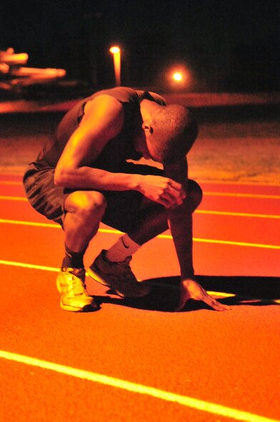 Airman 1st Class Marcus Toney recovers after sprinting a lap around the track in less than 70 seconds at Seymour Johnson Air Force Base, N.C., Nov. 8, 2011. Toney is currently training to apply for the Air Force track team, an elite group that competes in meets and tournaments nationwide. Prior to applying, Toney must compete in several track meets around North Carolina. Toney is an operations manager with the 4th Civil Engineer Squadron and is from San Antonio. (U.S. Air Force photo by Senior Airman Marissa Tucker)