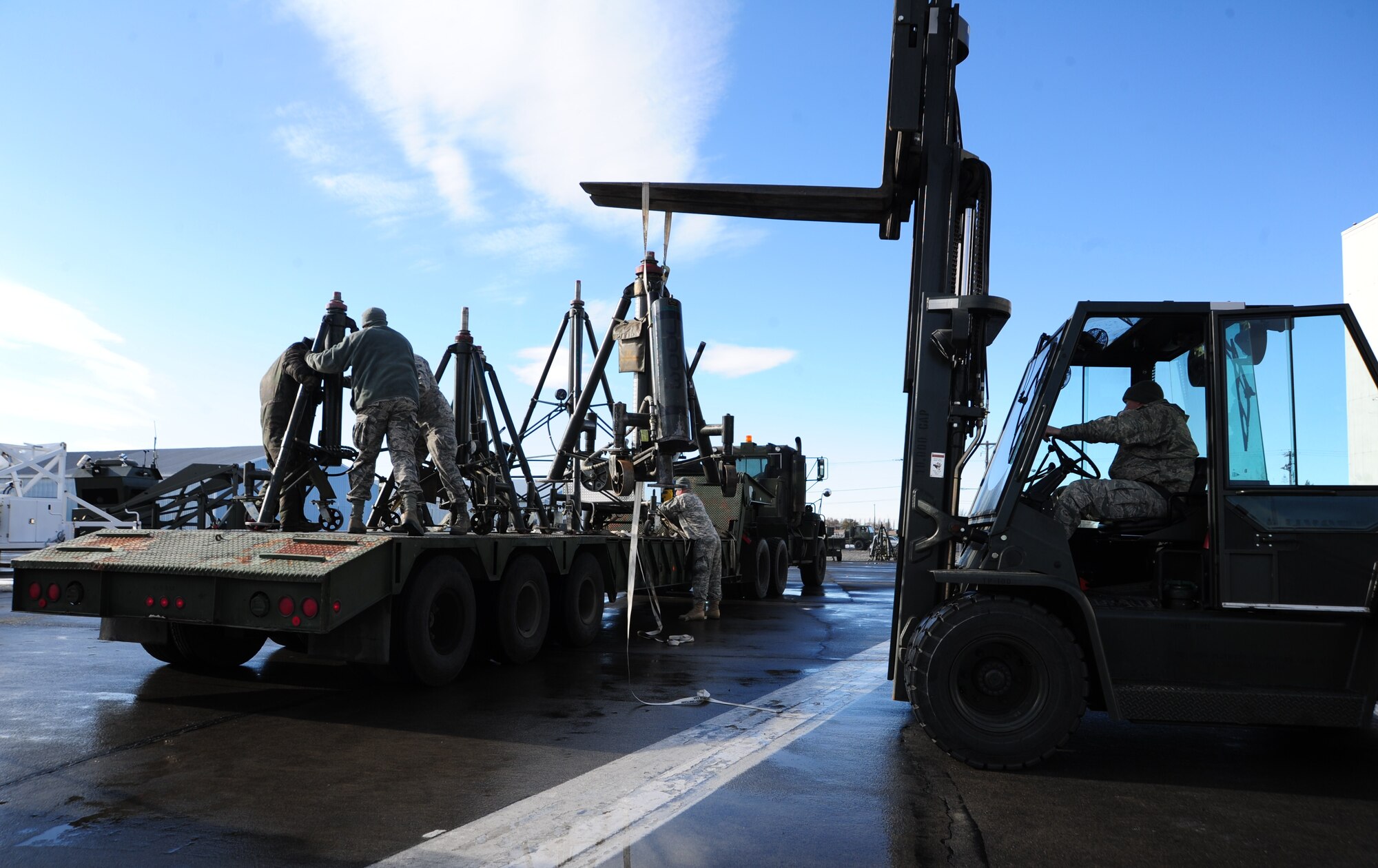 Air Force and Army personnel work together as a joint operation to load and bring all equipment from GCIA back to Fairchild Nov. 17. (U.S. Air Force photo/Airman 1st Class Taylor Curry)