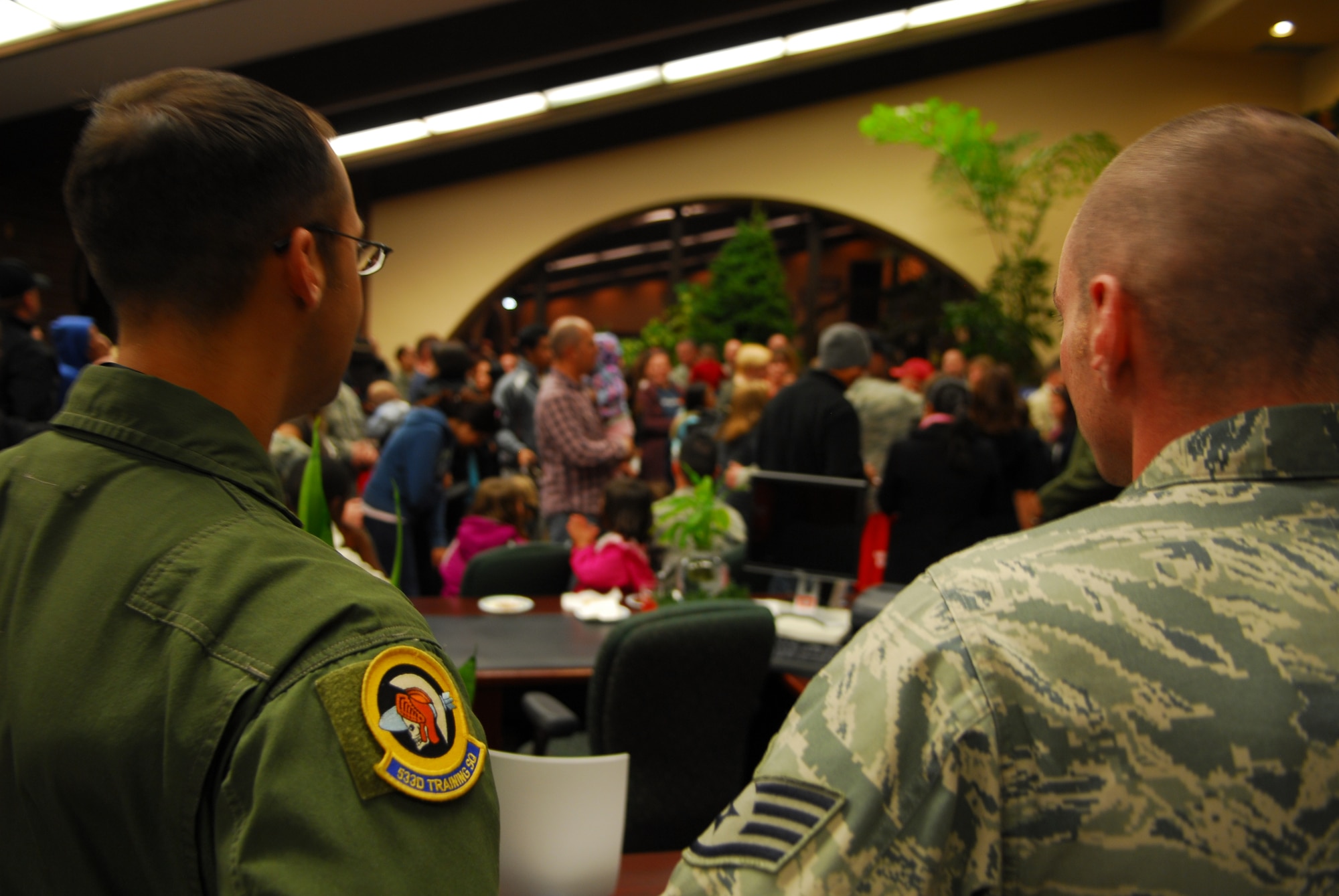 VANDENBERG AIR FORCE BASE, Calif. – Two Vandenberg Airmen listen to guest speakers during a ceremony in which holiday trees were donated to Vandenberg Airmen at the Santa Barbara Bank and Trust in Lompoc Wednesday, Nov. 30, 2011. (U.S. Air Force photo/Senior Airman Steve Bauer)