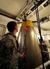 MINOT AIR FORCE BASE, N.D. – Staff Sgt. Wesley Baptiste, 91st Missile Maintenance Squadron missile maintenance instructor and Airman Daniel Peryer, 91st MMXS missile maintenance apprentice, perform a simulated missile reduction in accordance with the New Strategic Arms Reduction Treaty, here Nov. 29. New START is a treaty between the United States and the Russian Federation to reduce the number of strategic nuclear missile launchers. (U.S. Air Force Photo/Airman 1st Class Desiree Esposito)