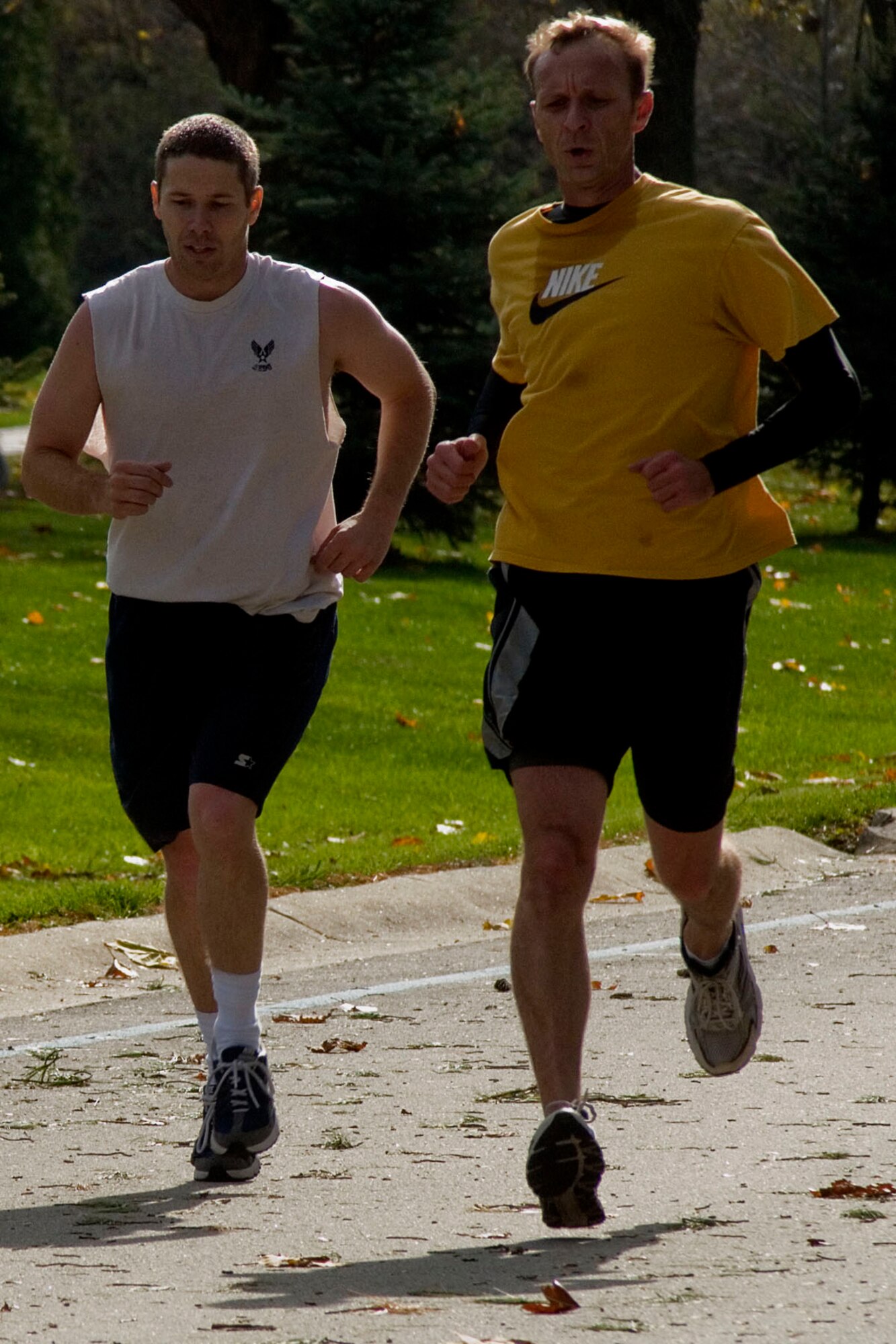 GRISSOM AIR RESERVE BASE, Ind. -- Chris Feltis, right, and Sam Pier make their way to the finish line during a 5-kilometer 'turkey trot' Nov. 15. The runners predicted their finish time prior to the race, and those who completed closest to their time bagged a turkey for the holidays. It was Paul Weimer, Robert Sucharski and Feltis who took home a bird.  (U.S. Air Force photo/ Senior Airman Jami K. lancette)
