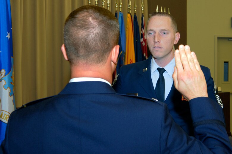 VANDENBERG AIR FORCE BASE, Calif. -- Col. David Hook, 30th Operations Group commander, administers the Oath of Enlistment to Chief Master Sgt. Matthew Lusson, the 30th OG superintendent, here Wednesday, Nov. 30, 2011. The rank of chief master sergeant is limited by federal law to only one percent of the Air Force enlisted force. (U.S. Air Force photo/Jerry E. Clemens, Jr.)
