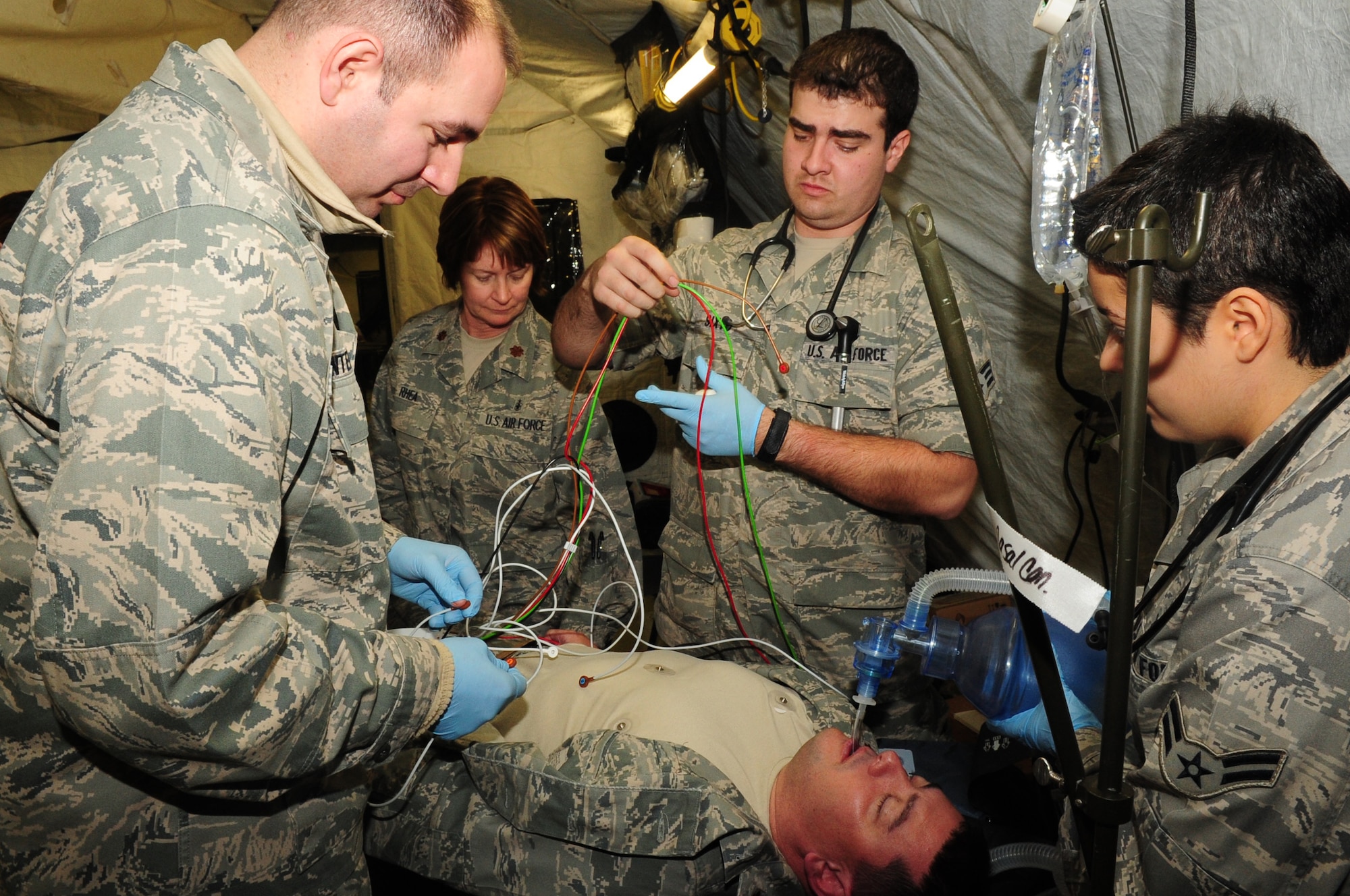 Medics try to resuscitate an Airman during an expeditionary Medical Support Exercise, Ramstein Air Base, Dec. 01, 2011. EMEDS was a week-long exercise for the 86th and 31st Medical Group to hone their skills in a mock-deployed environment. (U.S. Air Force photo by Senior Airman Aaron-Forrest Wainwright)