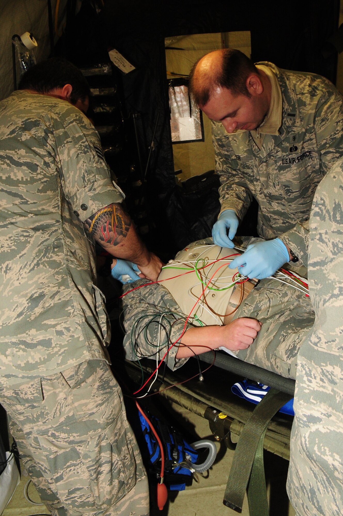 Medics try to resuscitate an Airman during an expeditionary Medical Support Exercise, Ramstein Air Base, Dec. 01, 2011. EMEDS was a week-long exercise for the 86th and 31st Medical Group to hone their skills in a mock-deployed environment. (U.S. Air Force photo by Senior Airman Aaron-Forrest Wainwright)