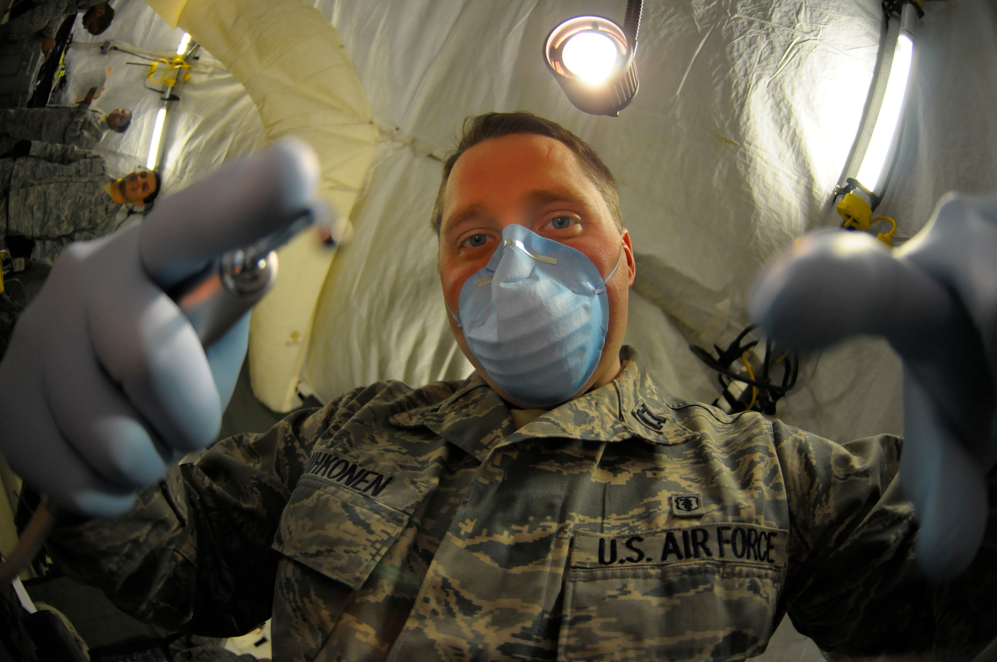 Capt. Rian Suihkonen, 86th Dental Squadron dentist, prepares to examine the mouth of his patient during the Expeditionary Medical Support Exercise at Ramstein Air Base, Germany, Dec. 1, 2011. EMEDS is a week-long exercise for the 86th and 31st Medical Groups to hone their skills in a mock-deployed environment. (U.S. Air Force photo by Staff Sgt. Travis Edwards)
