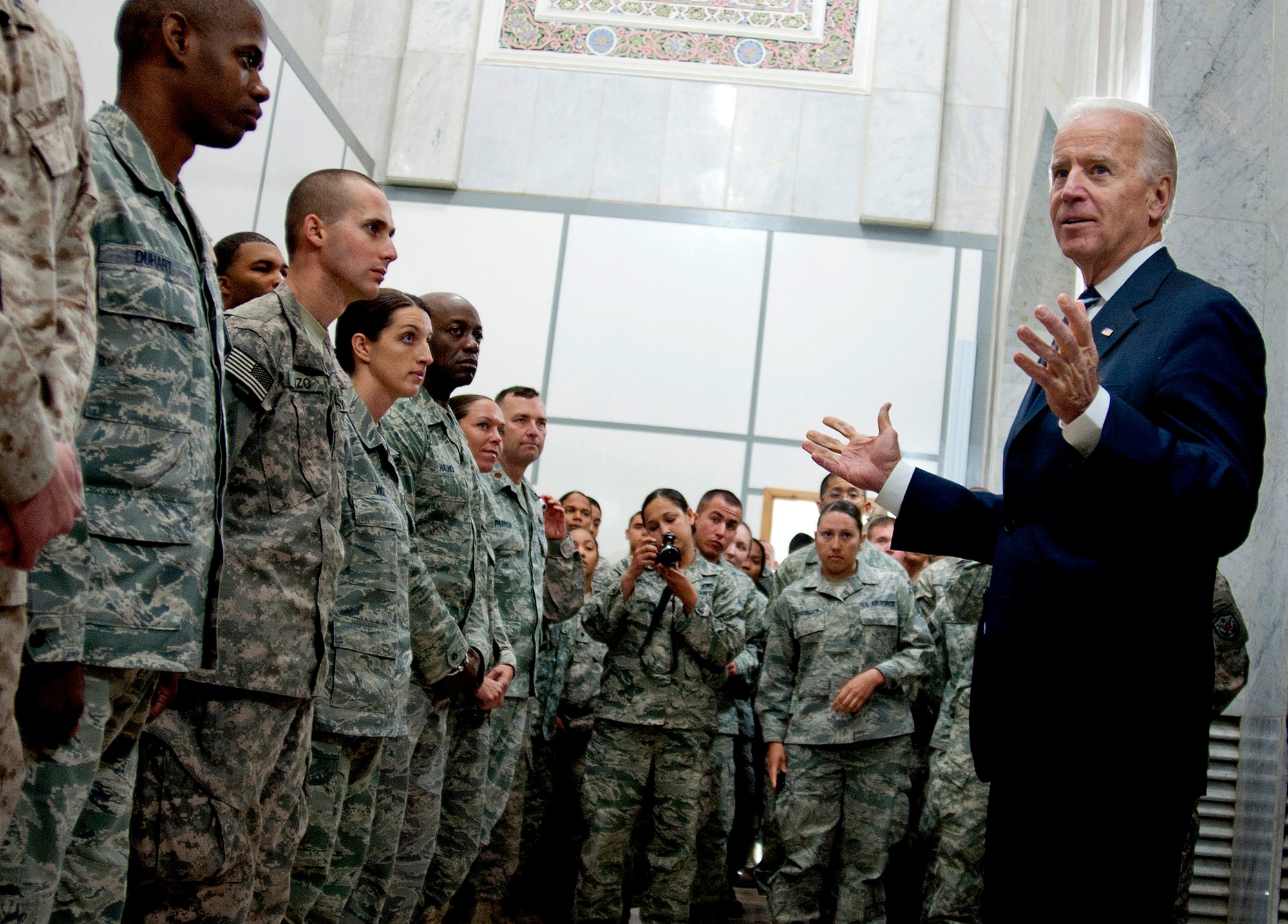 U.S. Vice President Joe Biden takes the time to talk to more than a hundred Airmen and Soldiers after the Government of Iraq Day of Commitment Ceremony in the Al Faw Palace at Victory Base Complex, Iraq, Dec. 1, 2011. The ceremony commemorated the sacrifices and accomplishments of U.S. and Iraqi service members. Vice President Biden shook hands, took pictures and provided each service member a coin. (U.S. Air Force photo/Master Sgt. Cecilio Ricardo)