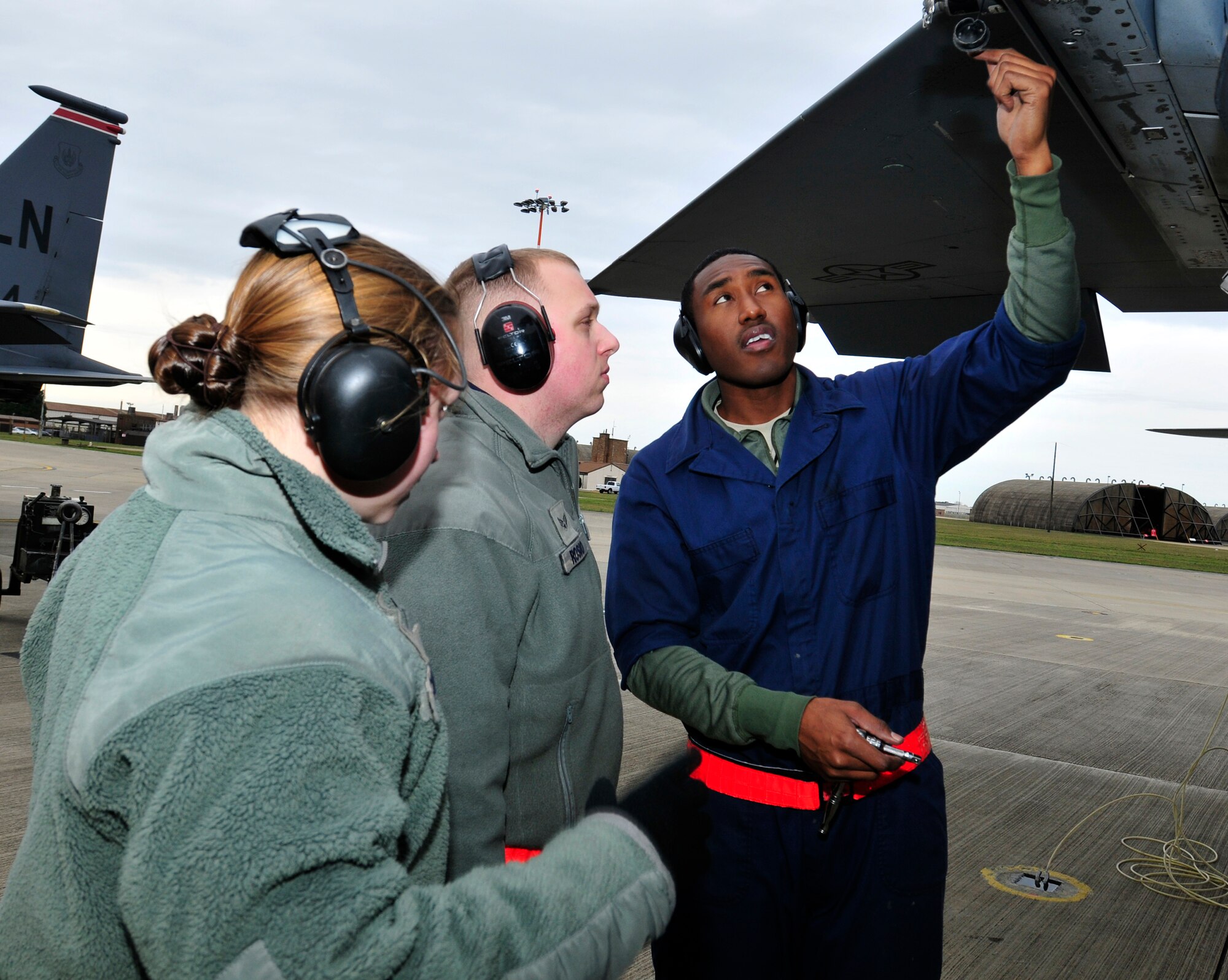 ROYAL AIR FORCE LAKENHEATH, England – (left to right) Airman 1st Class Ashton Colburn, 748th Aircraft Maintenance Squadron weapons team member, Senior Airman Timothy Rosio, 48th Aircraft Maintenance Squadron weapons team member and Staff Sgt. Arthur Belvin, 48th AMXS weapons load crew chief, perform an operations check on an F-15 Eagle on the flightline, Dec. 1, 2011. These Airmen contributed to the accomplishments which helped lead to Capt. William Bernecker, former 48th AMXS Officer in Charge, being awarded the Gen. Lew Allen Jr.Trophy. (U.S. Air Force photo by Senior Airman Tiffany M. Deuel)