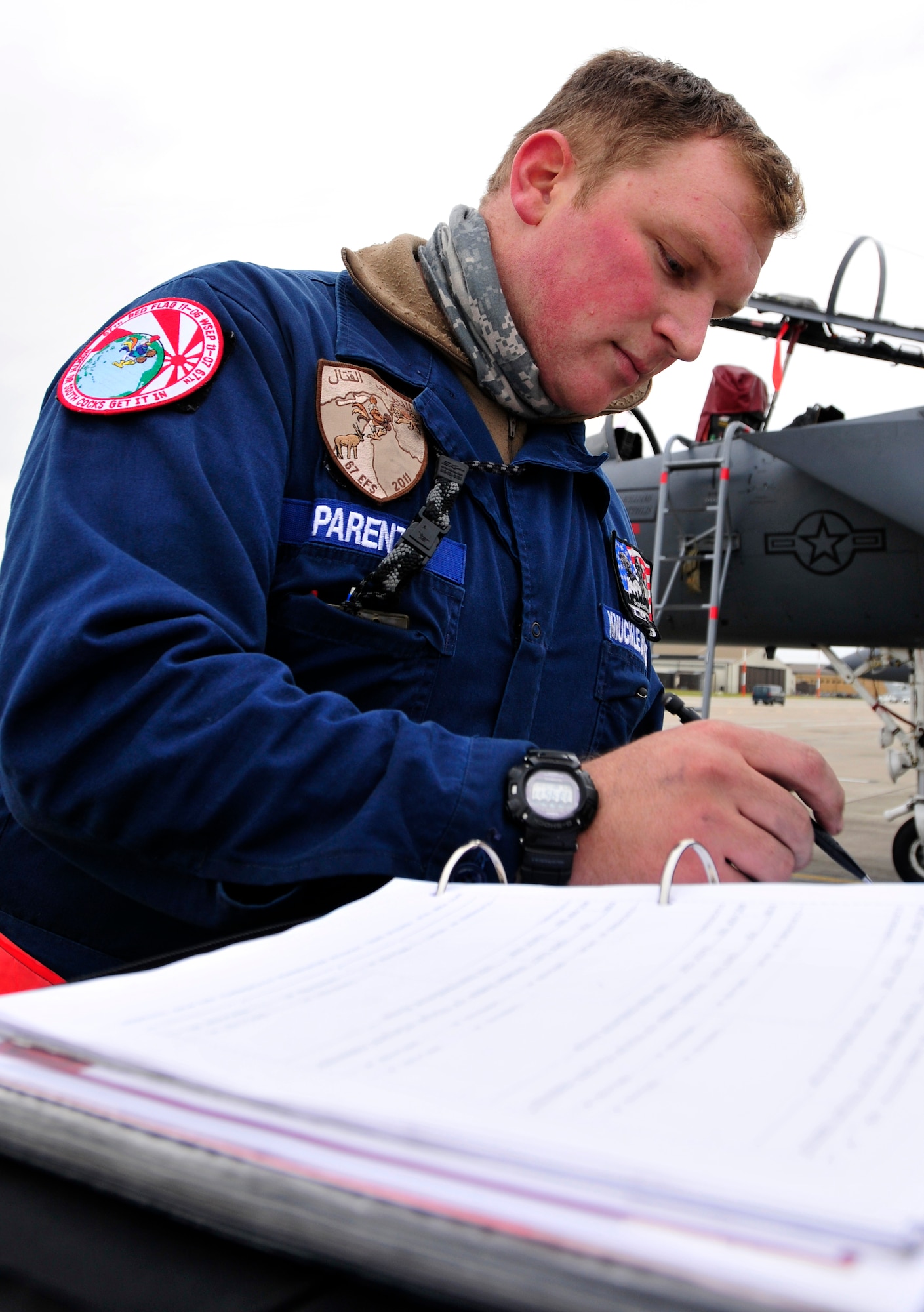 ROYAL AIR FORCE LAKENHEATH, England – Senior Airman Jordan Parente, 48th Aircraft Maintenance Squadron crew chief, fills out aircraft forms for new panels on the flightline, Dec. 1, 2011. Parente contributed to the accomplishments which helped lead to Capt. William Bernecker, former 48th AMXS Officer in Charge, being awarded the Gen. Lew Allen Jr. Trophy. (U.S. Air Force photo by Senior Airman Tiffany M. Deuel)