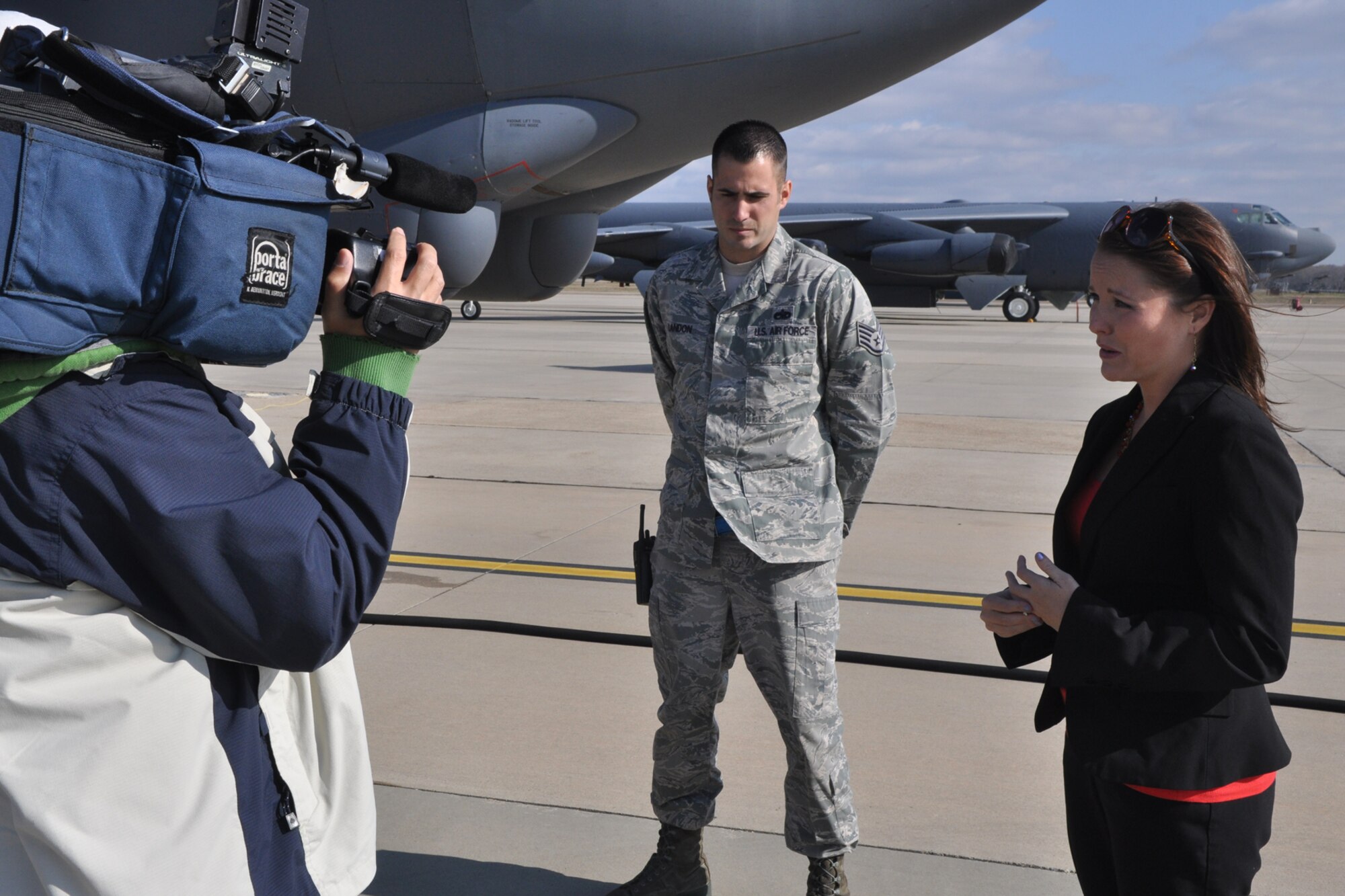 Leslie Draffin, who is a reporter and anchor for KTAL Channel 6 in Shreveport, La., reports a story at Barksdale Air Force Base., La., Nov. 28, 2011. Draffin was at Barksdale with her cameraman Chang Howang to report on Staff Sgt. Byron Landon, who is a repair and reclamation technician assigned to the 707th Maintenance Squadron. Landon went straight from being an Active Duty Airman assigned to the 2nd Maintenance Squadron to an Air Reserve Technician working for the 707th MXS at Barksdale. Landon made the transition from Active to Reserve almost overnight, all the while continuing his employment in the same shop. (U.S. Air Force photo by Master Sgt. Jeff Walston/Released)