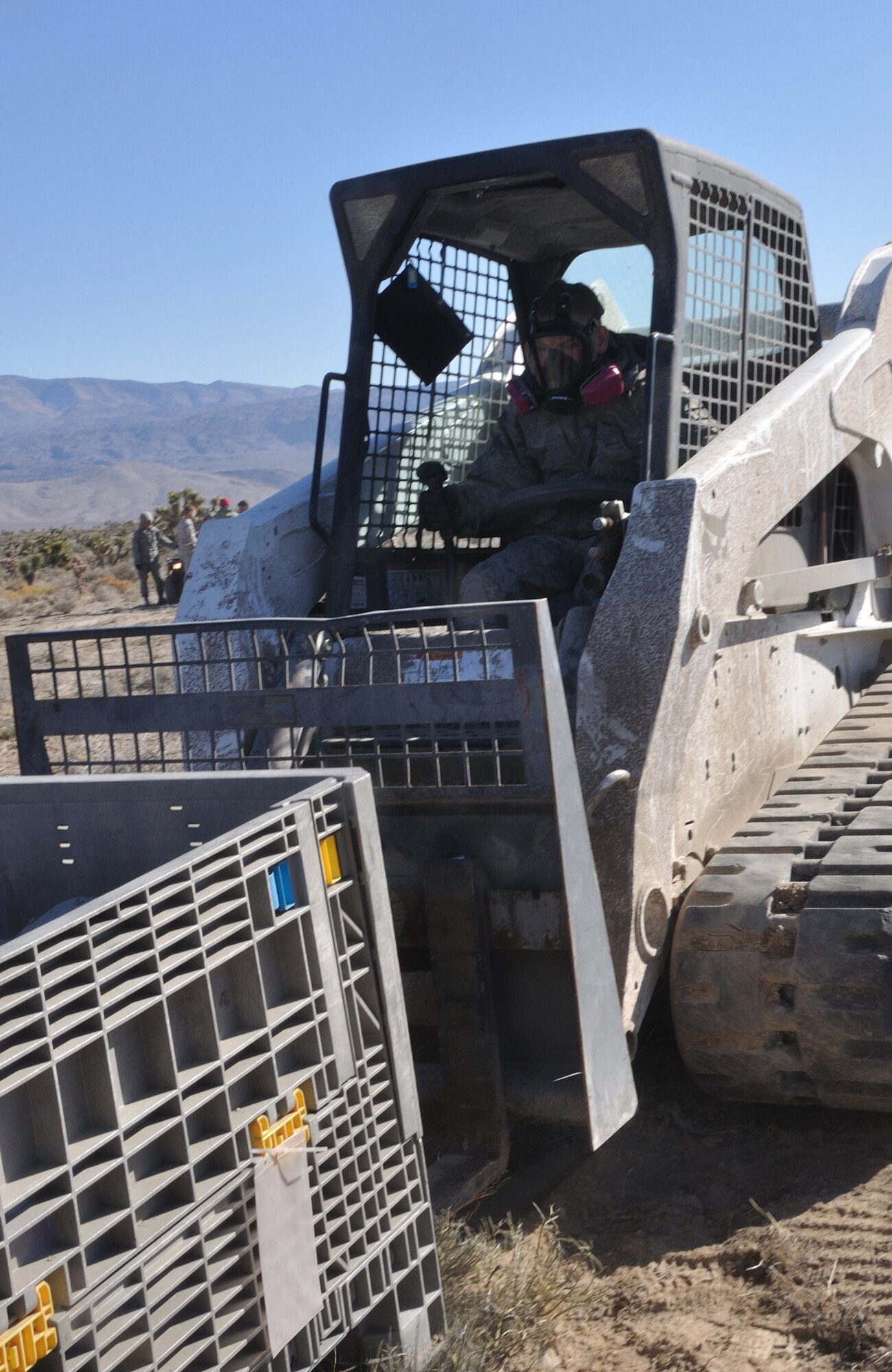 U.S. Air Force Airmen, 820th RED HORSE Squadron airborne flight, prepare to sling load a connex box to a CH-47 Chinook, Army National Guard, Stockton, CA, during a peacetime operation Nov. 9, 2011, near Alamo, Nev.The sling load training and air assault certification of 820th RHS airborne flight Airmen proved crucial in the success of the quick response operation. (U.S. Air Force photo by Tech Sgt. Bob Sommer/Released)