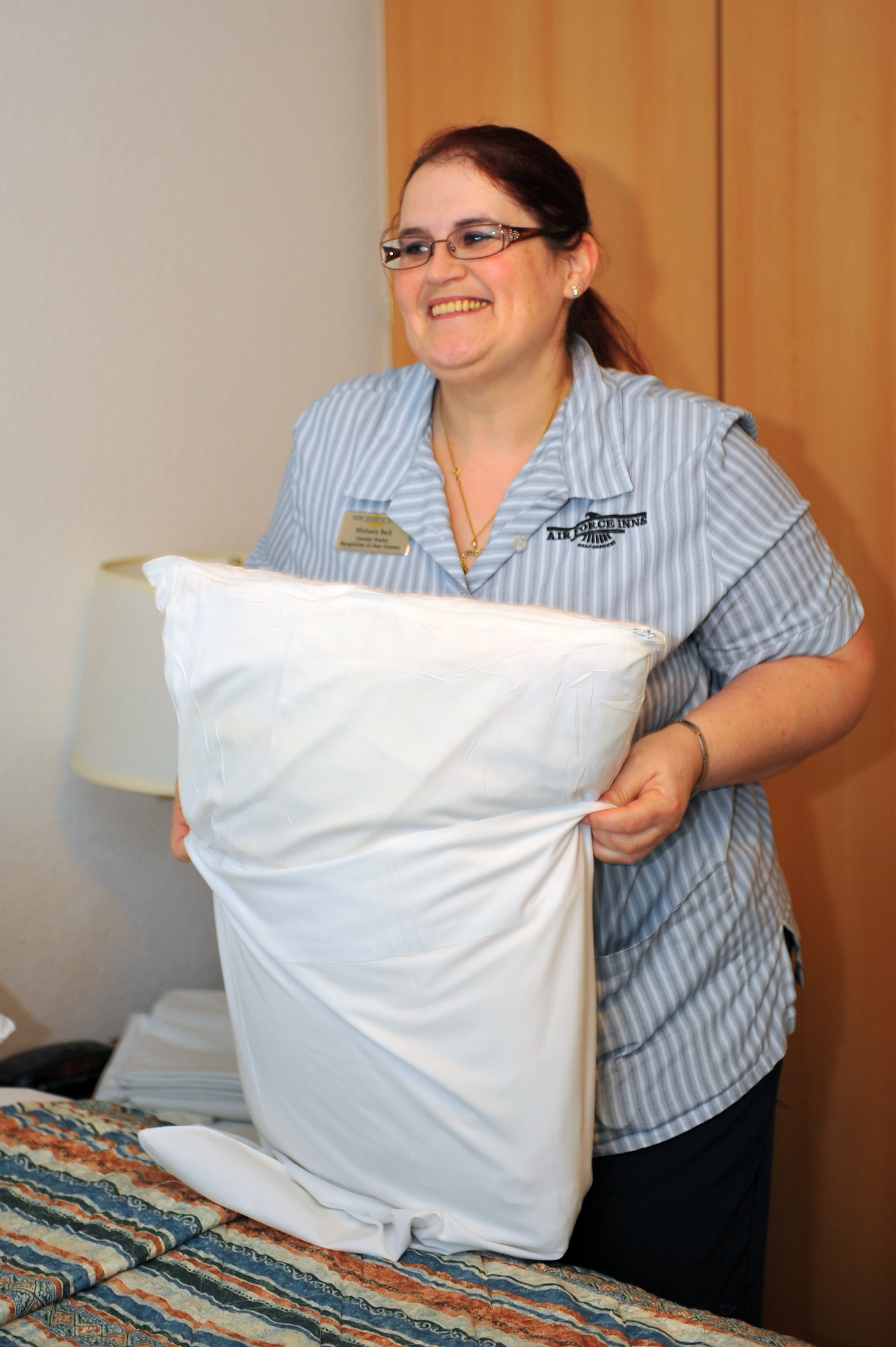 SPANGDAHLEM AIR BASE, Germany – Michaela Back, Eifel Arms Inn custodial worker, puts a clean pillow case on a pillow during a daily room cleaning in Bldg. 409 here Nov. 30. Eifel Arms Inn recently changed its policy to allow customers to make reservations more than 30 days in advance in an effort to improve their occupancy and quality of service. (U.S. Air Force photo/Airman 1st Class Dillon Davis)