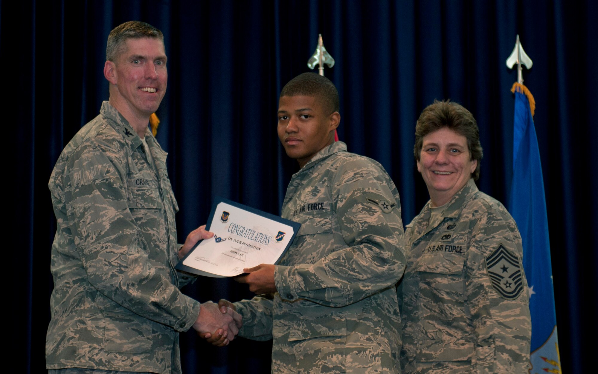 Jody Lee, 39th Medical Support Squadron, is promoted to the rank of airman Nov. 30, 2011, in the Club Complex ballroom at Incirlik Air Base, Turkey. (U.S. Air Force photo by Senior Airman Anthony Sanchelli/Released)