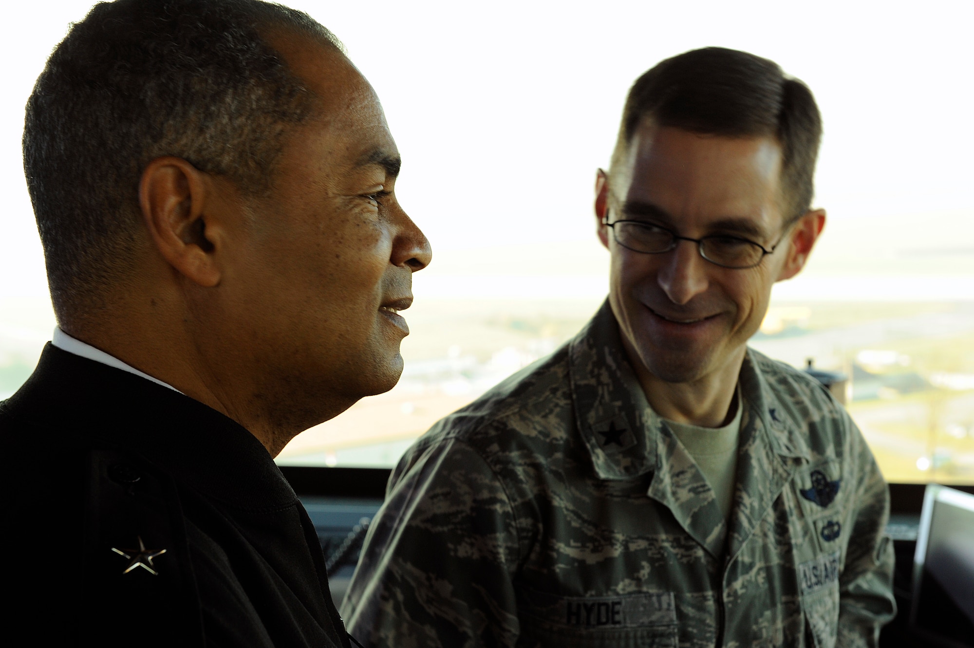 Brig. Gen. C.K. Hyde, 86th Airlift Wing commander, shares a moment with Brig. Gen. Aundre Piggee, 21st Theater Sustainment Command commander, during a Team Ramstein visit at the air traffic control tower Nov. 23. Piggee received a tour of the air traffic control tower and short mission briefs from Col. Kip Turain, 521st Air Mobility Operations Wing commander, Col. John Murphy, 435th Air Ground Operations Wing vice commander, and Hyde. (U.S. Air Force photo by Senior Airman Stephen Otero)