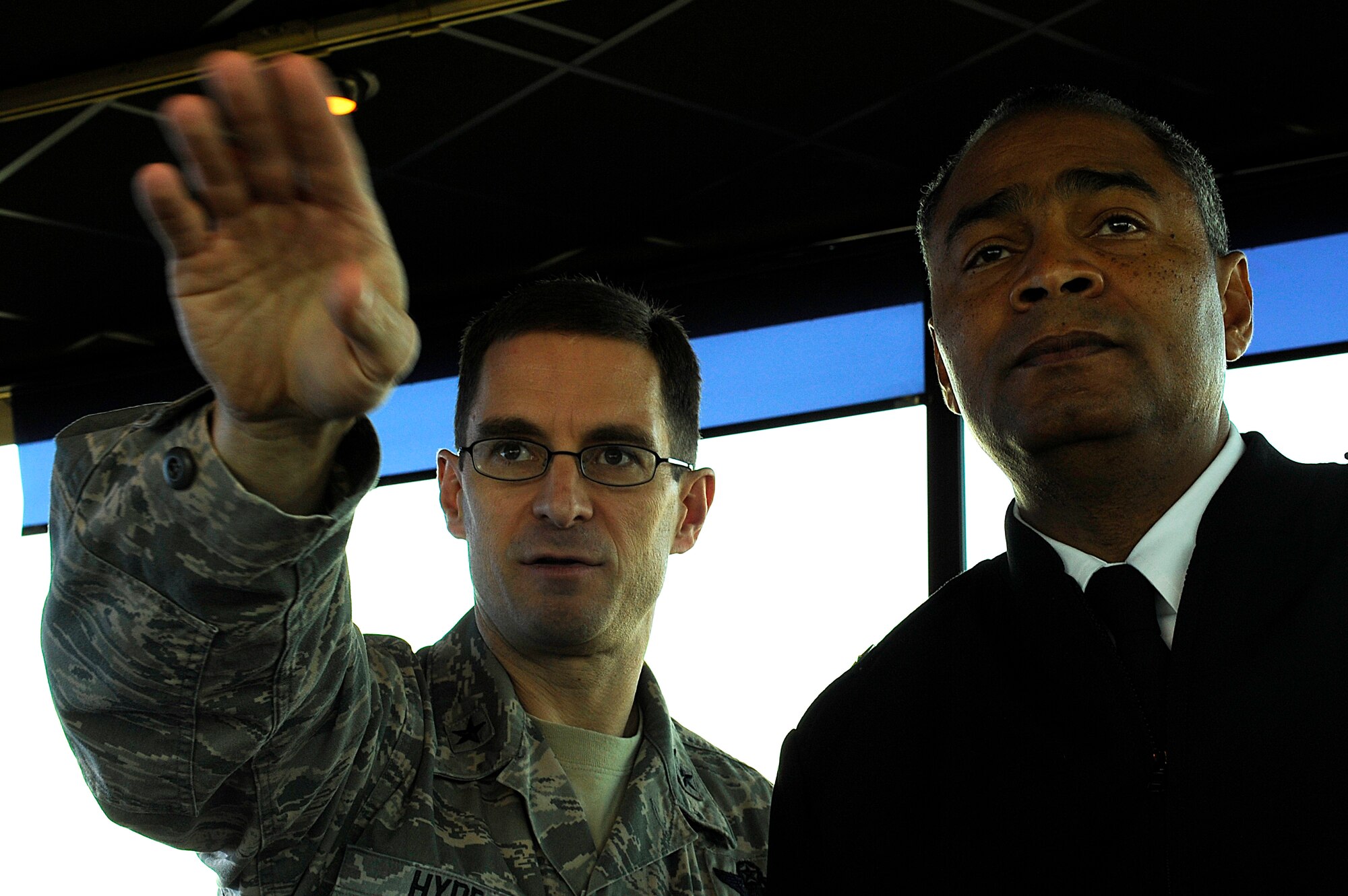 Brig. Gen. C.K. Hyde, 86th Airlift Wing commander, explains a section of the
flightline to Brig. Gen. Aundre Piggee, 21st Theater Sustainment Command
commander, during a Team Ramstein visit at the air traffic control tower
Nov. 23. Piggee received a tour of the air traffic control tower and short mission briefs from Col. Kip Turain, 521st Air Mobility Operations Wing commander, Col. John Murphy, 435th Air Ground Operations Wing vice commander, and Hyde. (U.S. Air Force photo by Senior Airman Stephen Otero)
