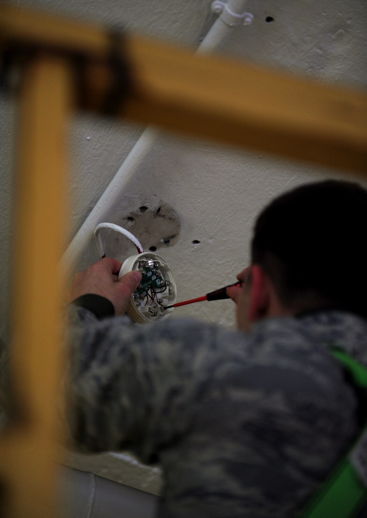 SPANGDAHLEM AIR BASE, Germany – Airman 1st Class Troy Heirling, 52nd Civil Engineer Squadron electrical-systems apprentice, removes a damaged fire detector in bldg 189 here Nov. 28. The alarm shop is responsible for maintaining, replacing and monitoring all base security and fire-alarm systems. (U.S. Air Force photo/Airman 1st Class Matthew B. Fredericks)