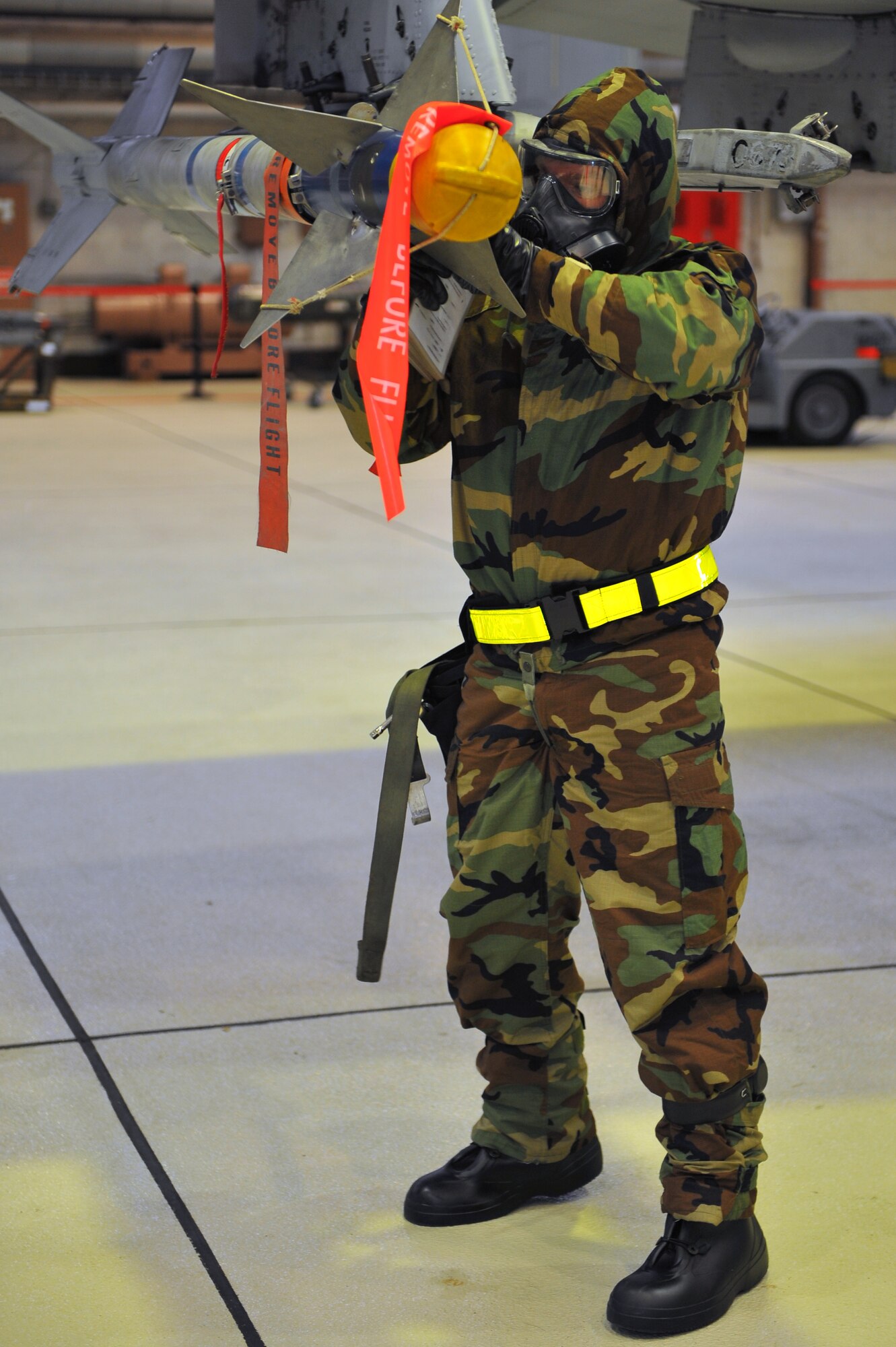 SPANGDAHLEM AIR BASE, Germany – Staff Sgt. Paul Garton, 52nd Aircraft Maintenance Squadron load-crew chief, secures an AIM-9 missile to the wing of an A-10 Thunderbolt II during a munitions-loading evaluation here Nov. 29. The evaluation ensures load-crew members and team chiefs retain their qualification to load all munitions and are ready for mission taskings. Crew members complete an evaluation every month and are required to be evaluated annually while wearing chemical-warfare gear. (U.S. Air Force photo/Airman 1st Class Dillon Davis)
