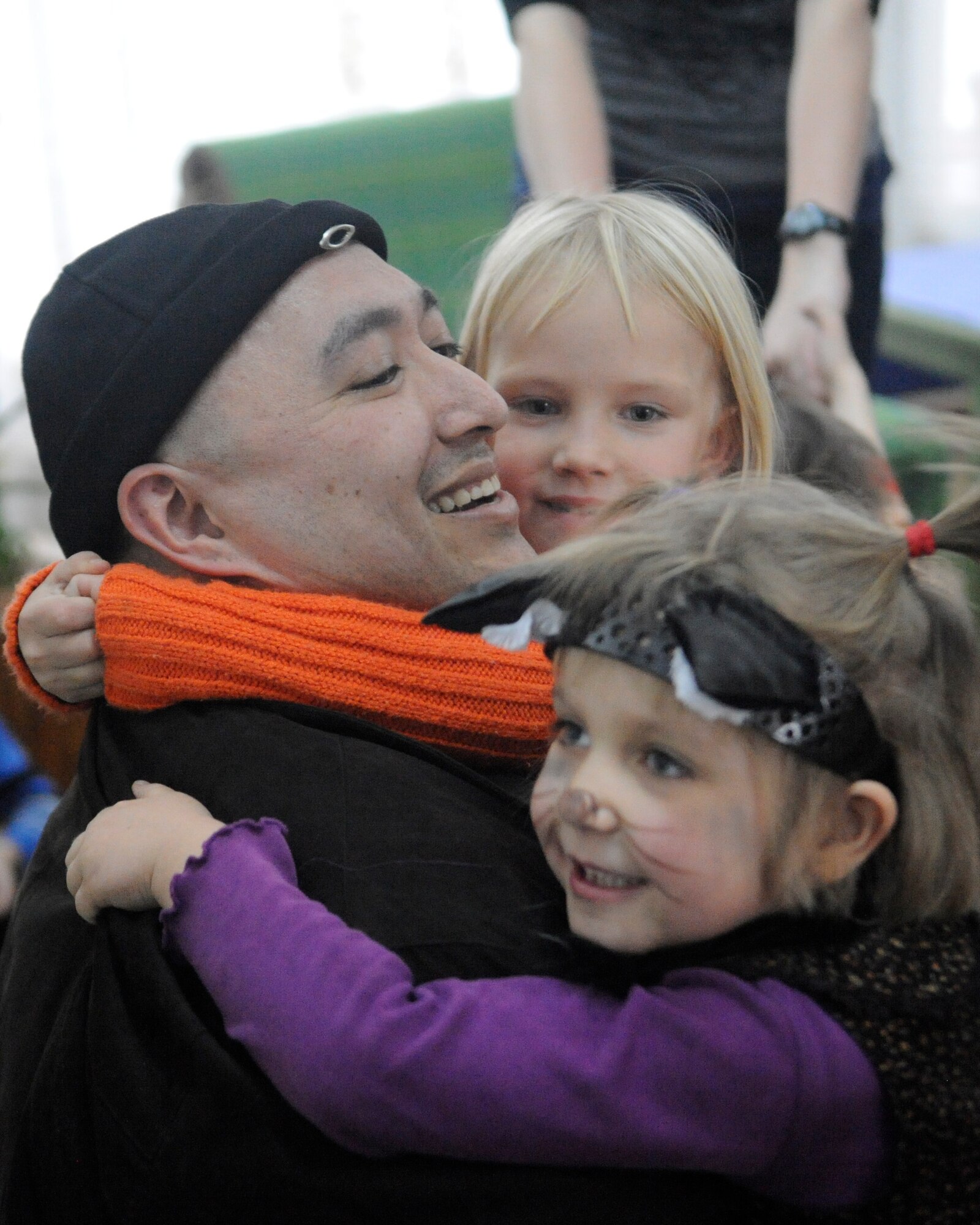 Tech. Sgt. Gerald Borchert receives hugs at the Belovodosky Orphanage during a Manas Area Benefit Outreach Society visit Nov. 28, 2011. MABOS members delivered clothing and toys to the children and spent time playing with them. Borchert is deployed to the Transit Center at Manas, Kyrgyzstan, as the 376th Expeditionary Logistics Readiness Squadron asset management section chief from Yokota Air Base, Japan. (U.S. Air Force photo/Tech. Sgt. Tammie Moore)