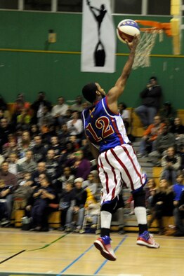 Ant Atkinson, Harlem Globetrotter member, completes a lay-up shot at the Edgren High School gymnasium, Misawa Air Base, Japan, Nov. 30, 2011, during their 11th annual holiday tour. The Harlem Globetrotters are an exhibition basketball team that combine athleticism, theater and comedy into their routines. (U.S. Air Force photo/Tech. Sgt. Marie Brown/Released) 
