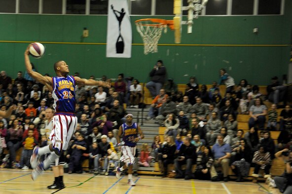 Hacksaw Hall, Harlem Globetrotter member, slam dunks a basketball at the Edgren High School gymnasium, Misawa Air Base, Japan, Nov. 30, 2011, during their 11th annual holiday tour. The Harlem Globetrotters are an exhibition basketball team that combine athleticism, theater and comedy into their routines. (U.S. Air Force photo/Tech. Sgt. Marie Brown/Released) 
