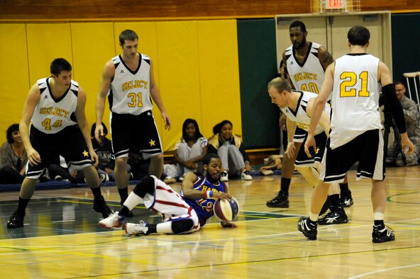 Ant Atkinson, Harlem Globetrotter member, shows off his skills in front of members of team "Globe Select" at the Edgren High School gymnasium, Misawa Air Base, Japan, Nov. 30, 2011, during their 11th annual holiday tour. The Harlem Globetrotters are an exhibition basketball team that combine athleticism, theater and comedy into their routines. (U.S. Air Force photo/Tech. Sgt. Marie Brown/Released) 
