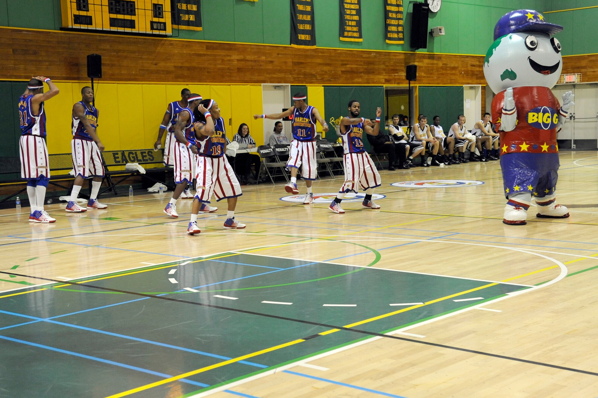 MISAWA AIR BASE, Japan - The Harlem Globetrotters and mascot "Big G" perform a dance routine at the Edgren High School gymnasium here Nov. 30 during their 11th annual holiday tour. The Harlem Globetrotters are an exhibition basketball team that combine athleticism, theater and comedy into their routines. (U.S. Air Force photo/Tech. Sgt. Marie Brown)