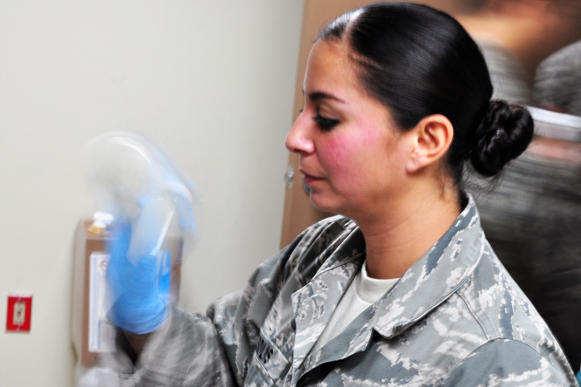 Senior Airman Sara Solis, 51st Aerospace Medicine Squadron Bioenvironmental Flight, shakes a water sample prior to placing it in an incubator to check for bacteria Dec. 1, 2011. Recently the base has experienced a change in taste and smell of the base water, which was caused by harmless algae that formed in the Seoul treatment plant due to the change in weather. Base water is still safe to drink but may take a few weeks to get back to normal. (U.S. Air Force photo/Tech. Sgt. Chad Thompson)