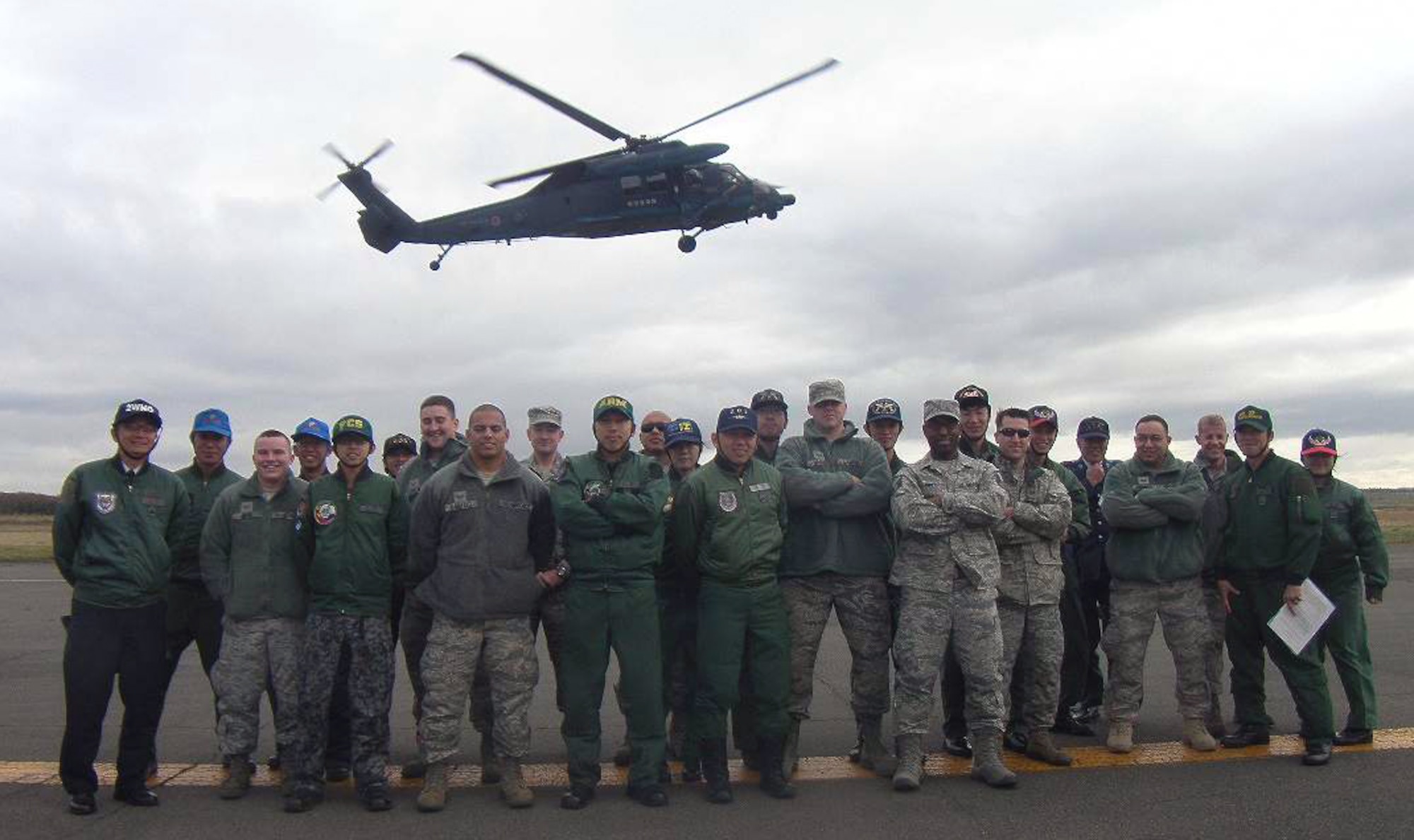 MISAWA AIR BASE, Japan- U.S. Air Force airmen from Misawa Air Base pose with Japan Air Self-Defense Force airmen from Chitose Air Base, on the northern Japanese island of Hokkaido, during a bilateral exchange Nov.17. The Misawa Bilateral Exchange Program is a program which allows Misawa airmen of various ranks to visit JASDF air bases and share cultural experiences. (Courtesy photo by Master Sgt. Joseph Finney)

